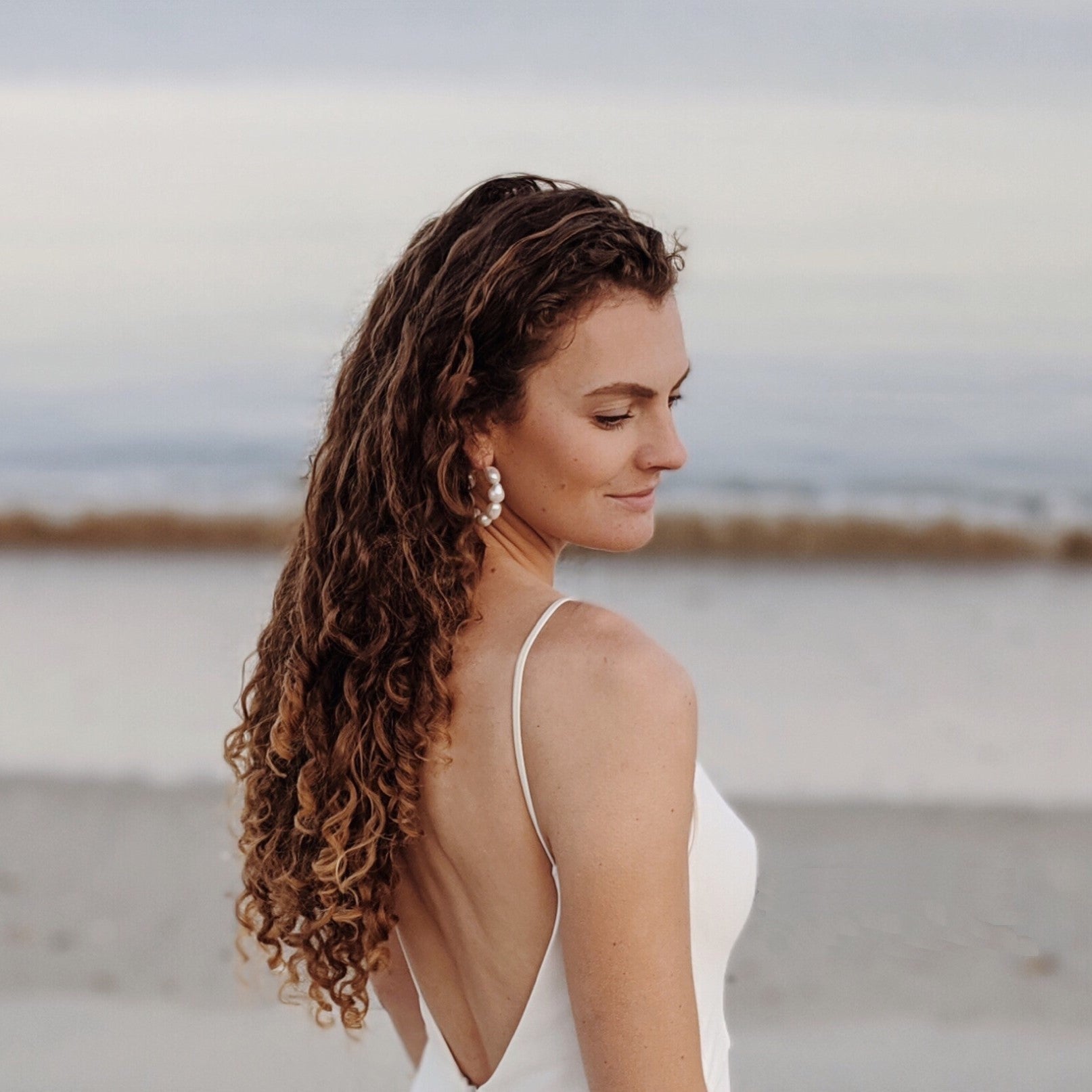 Bridal jewellery model white dress beach