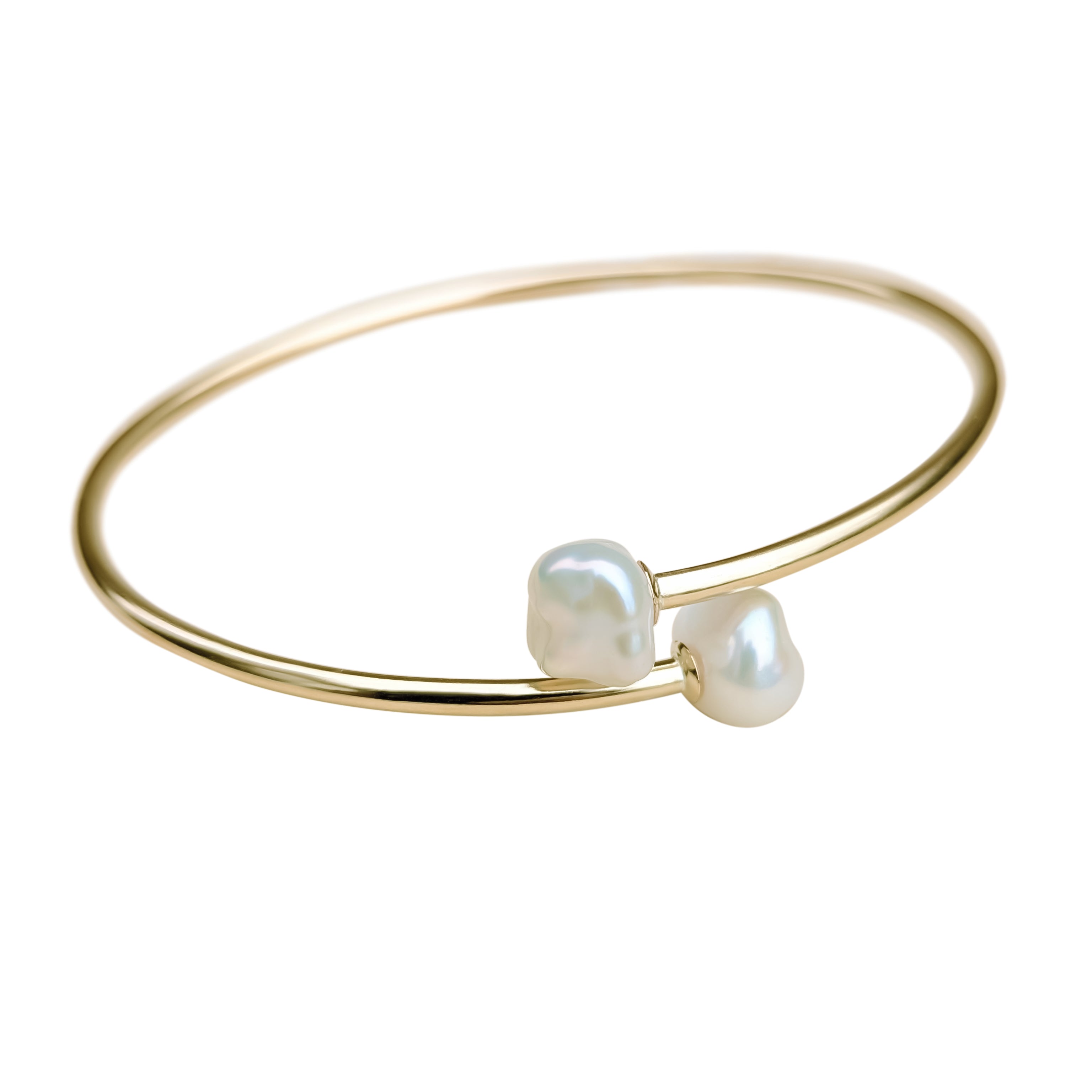 flexible pearl bangle in gold filled on a white background