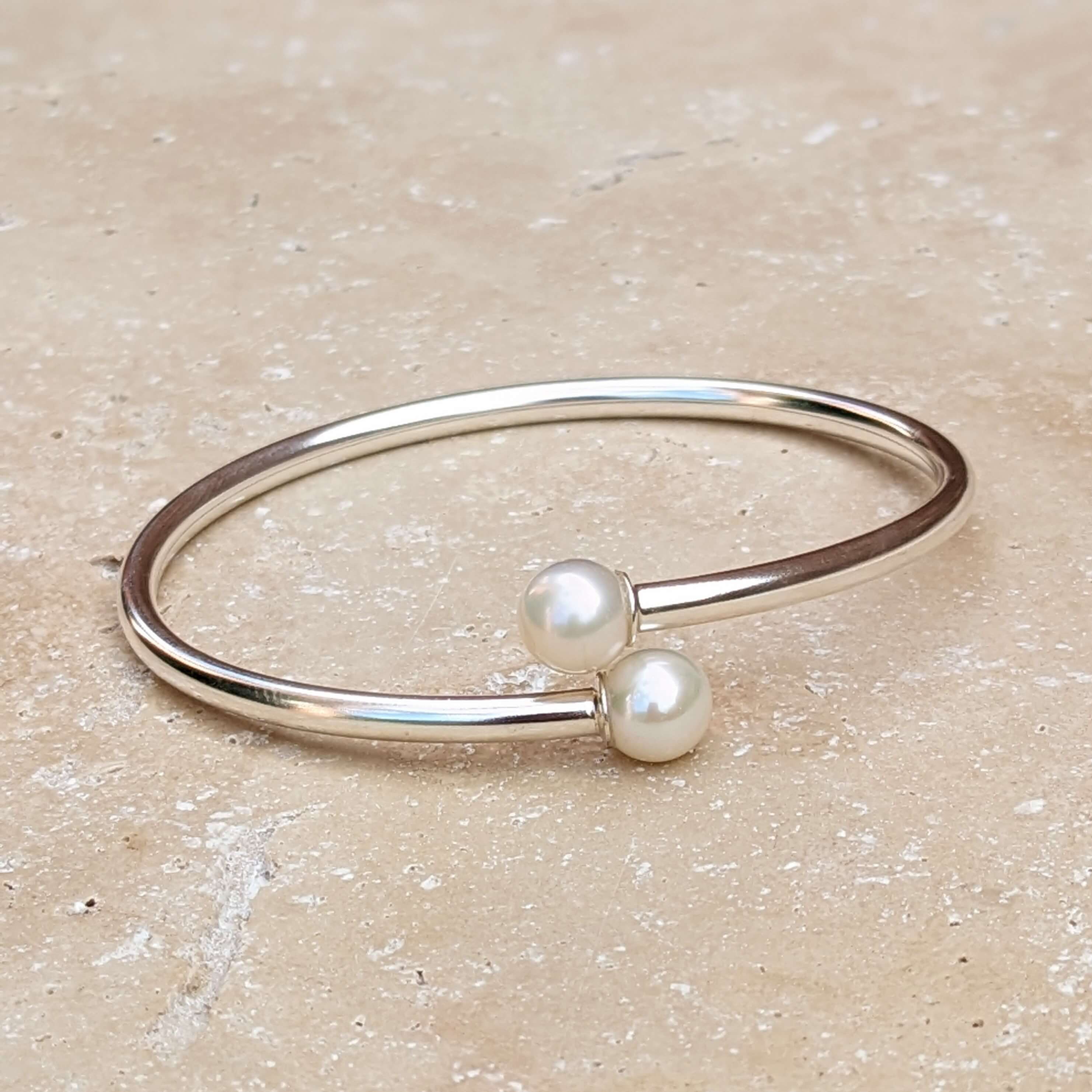 sterling silver pearl bangle on background