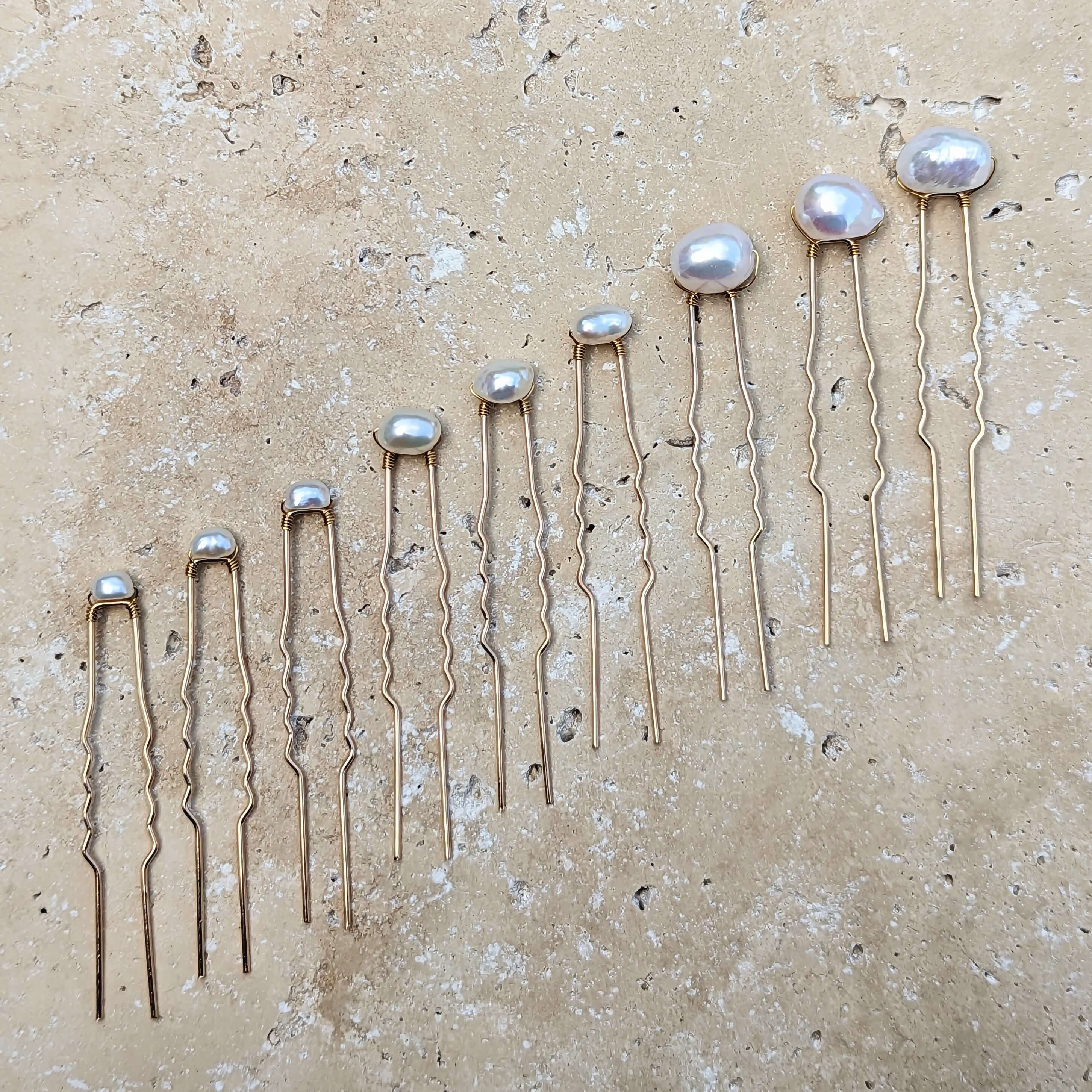 set of nine mixed size pearl hair pins set in gold