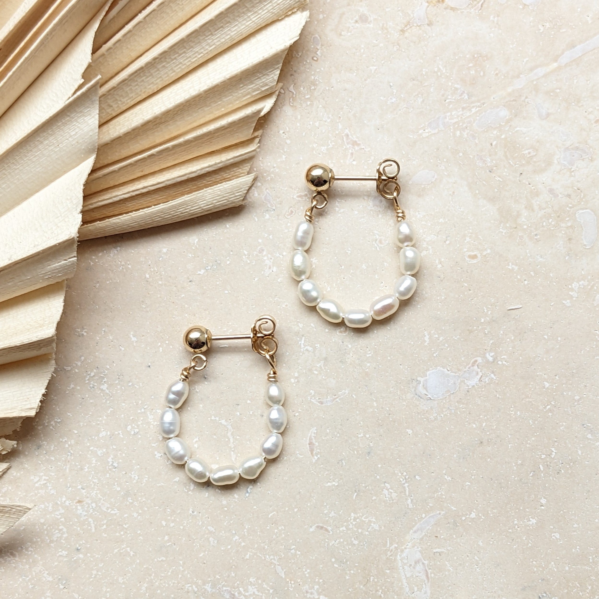 seed pearl hoop earrings in gold filled flat lay