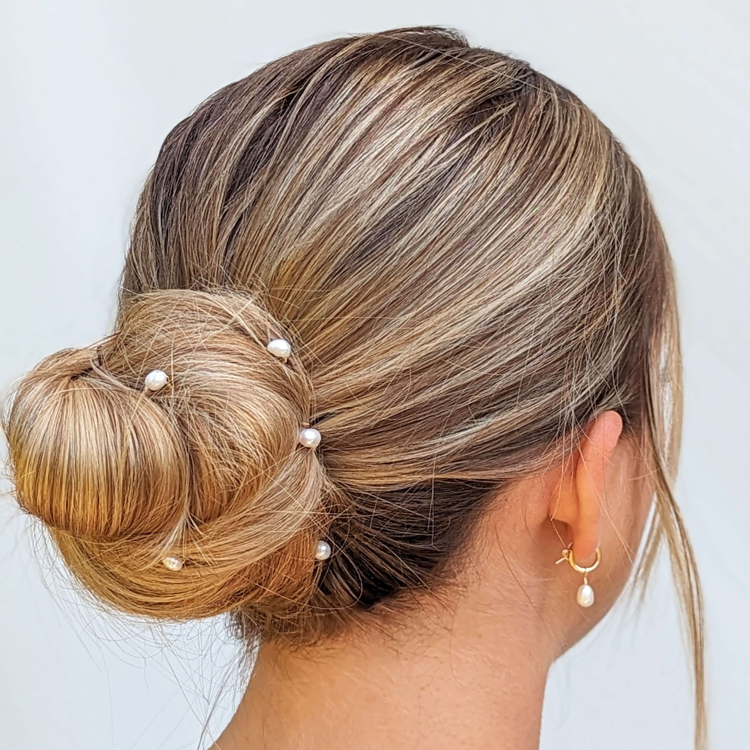 small pearl hair pins on bride in hair