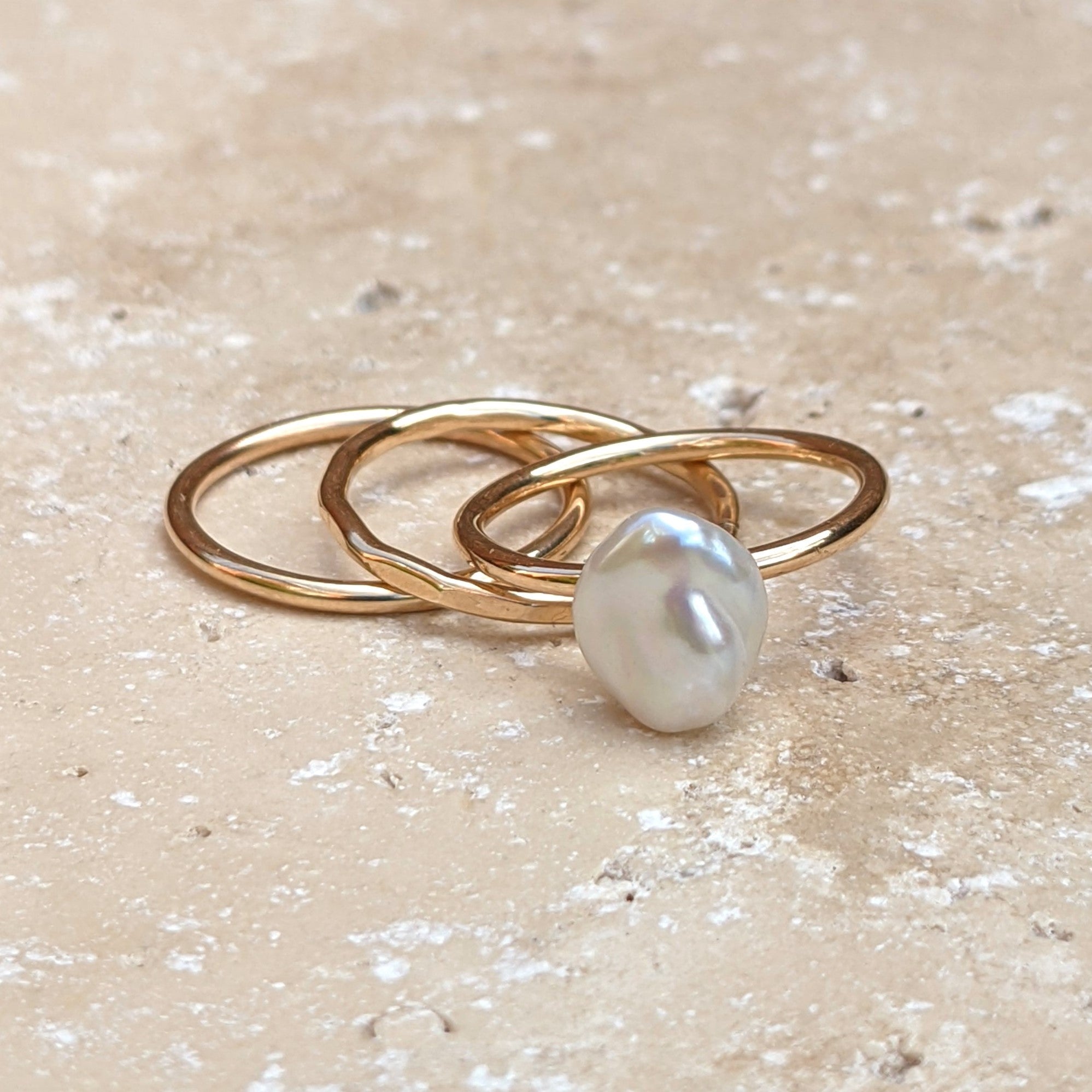Set of three gold rings - plain hammered and pearl