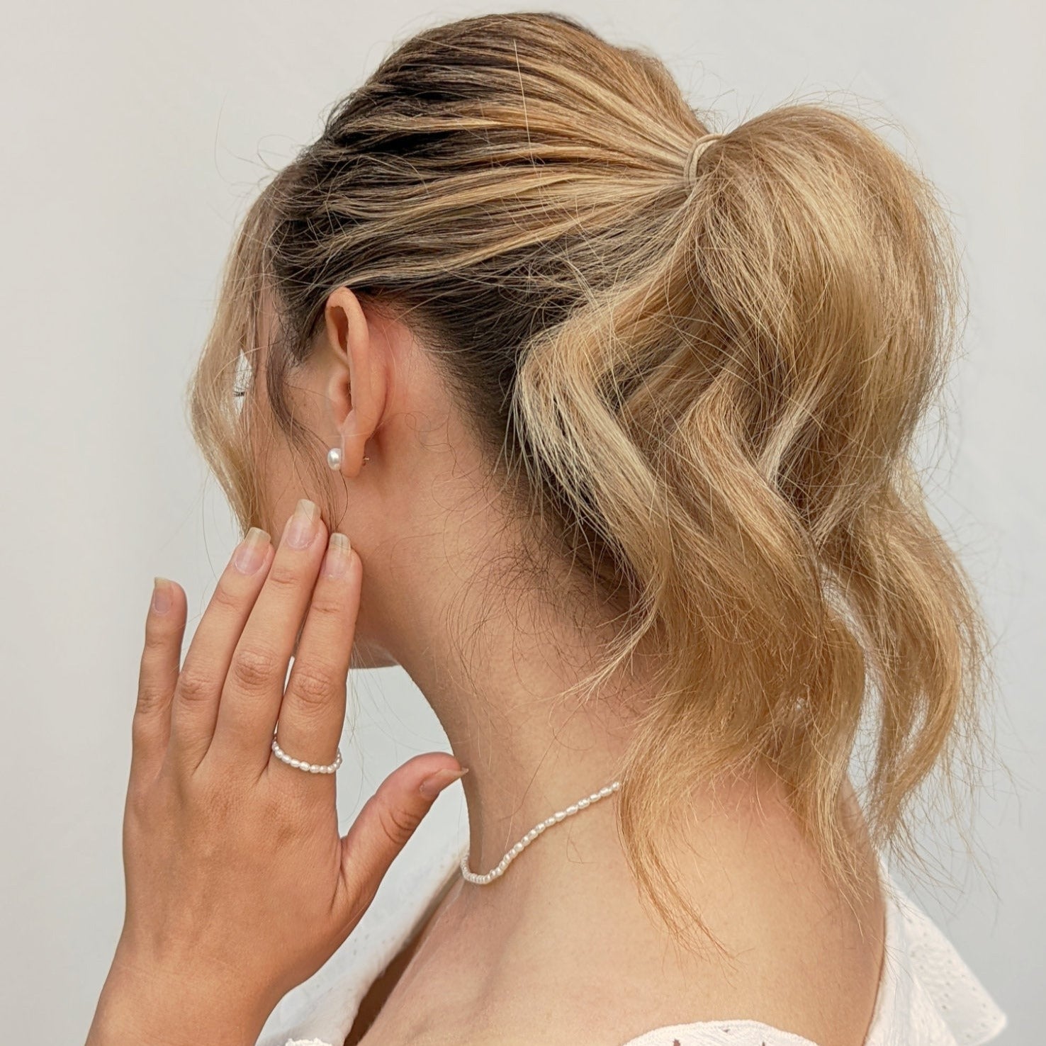 Back of model wearing pearl jewellery