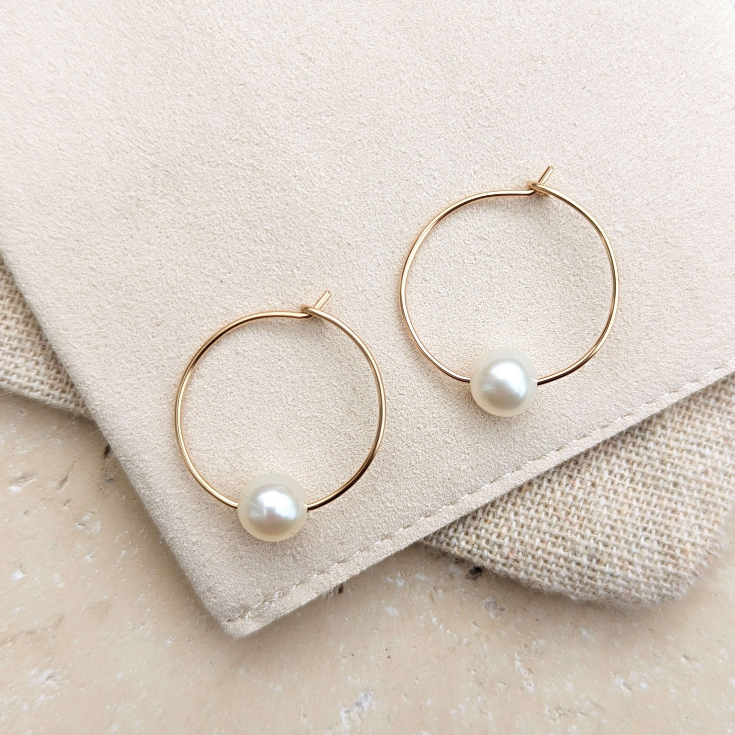 wire hoop round pearl earrings in gold filled flatlay