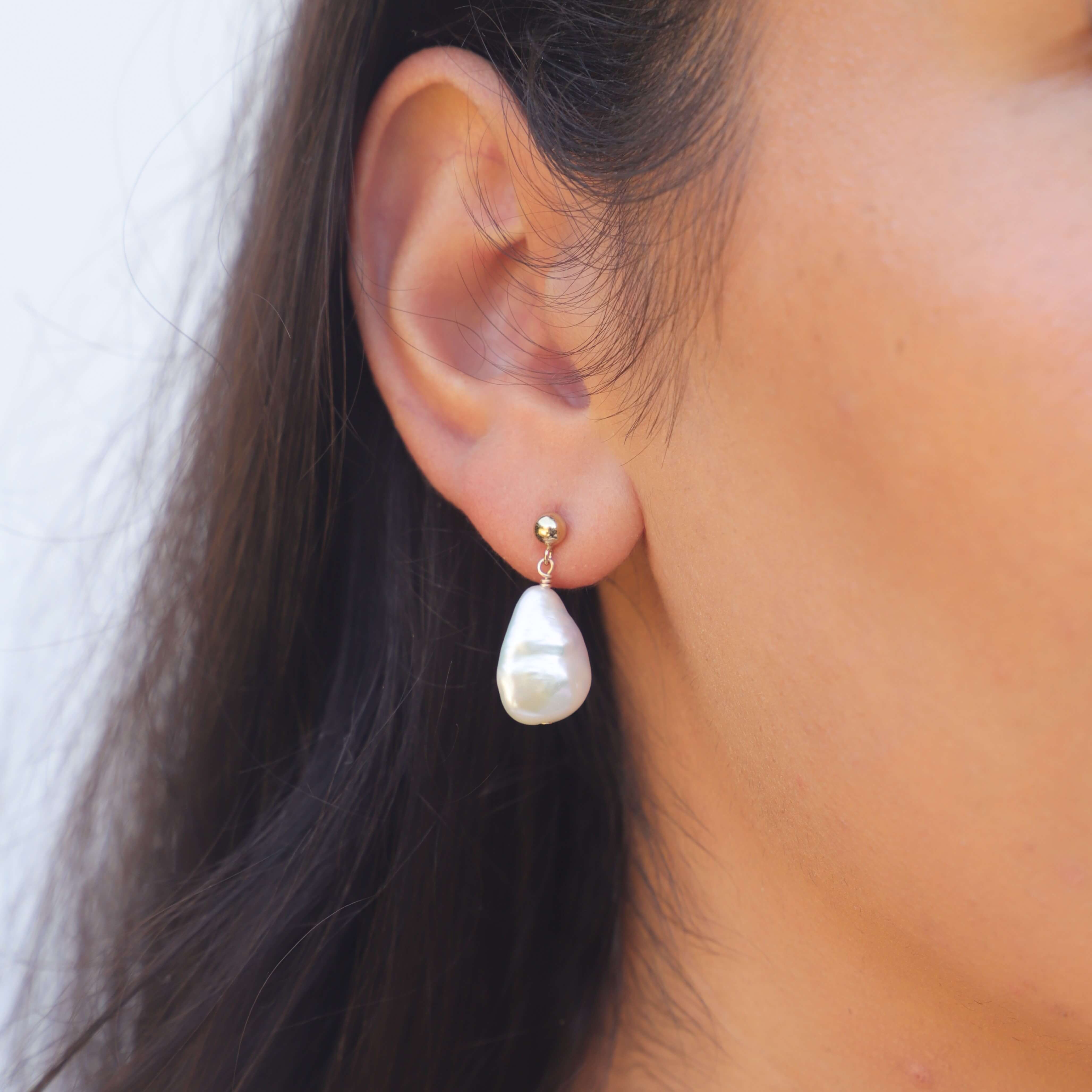 teardrop pearl earring on model's ear
