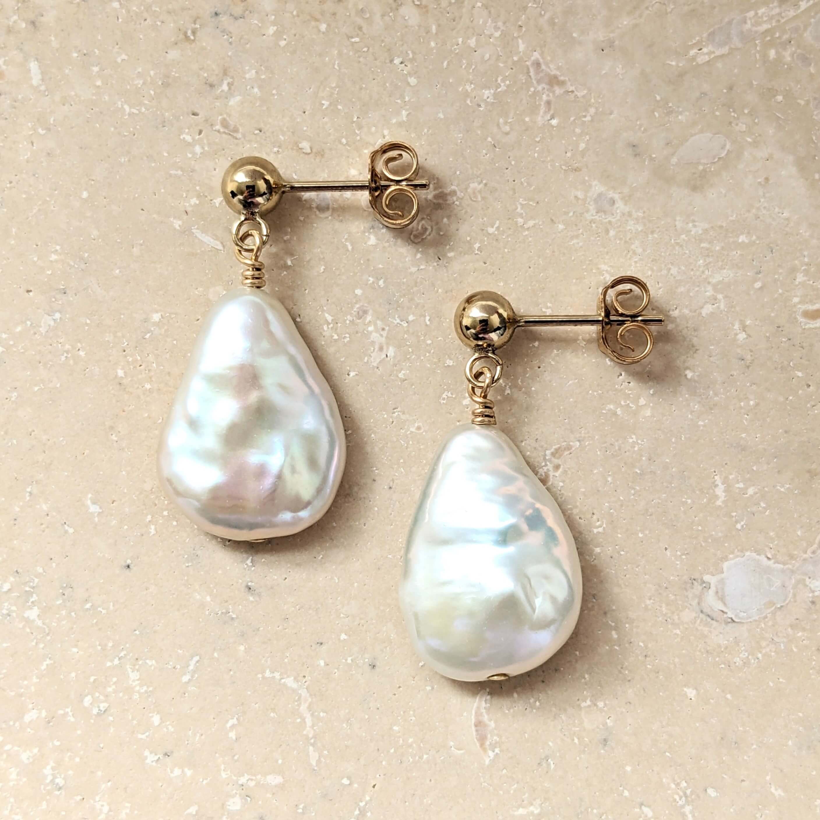 Flat teardrop shaped pearl earring with gold ball stud