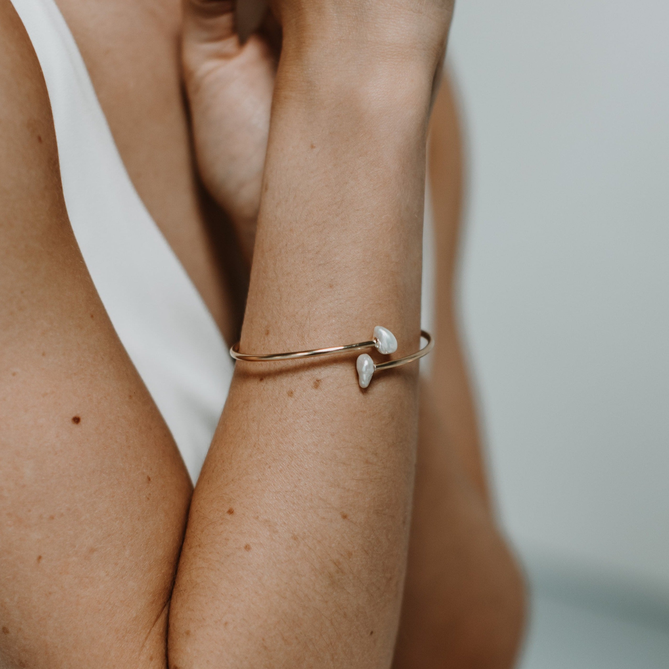 flexiable pearl bypass bangle in gold filled on bridal model