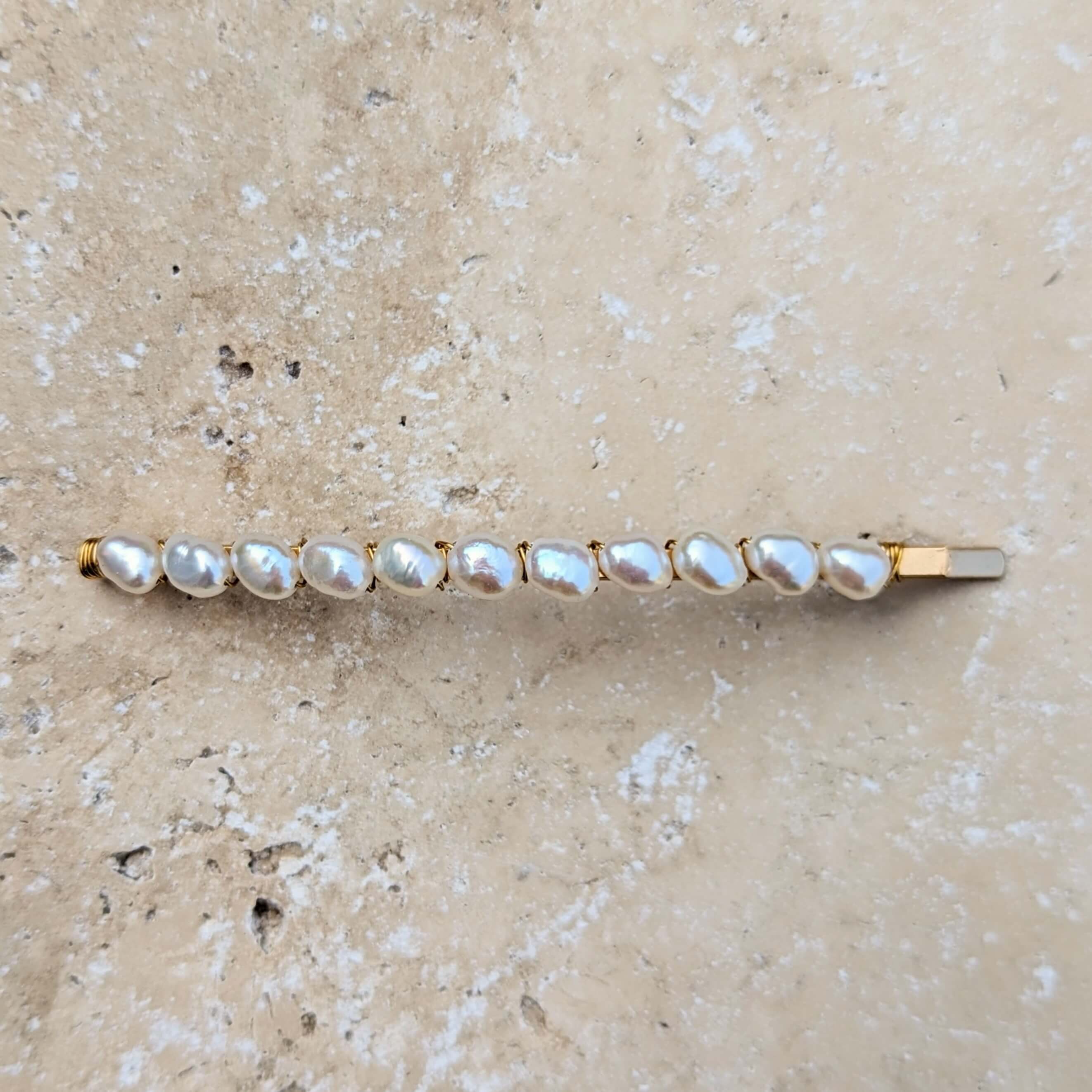 freshwater pearl hair slide long shot from above in gold