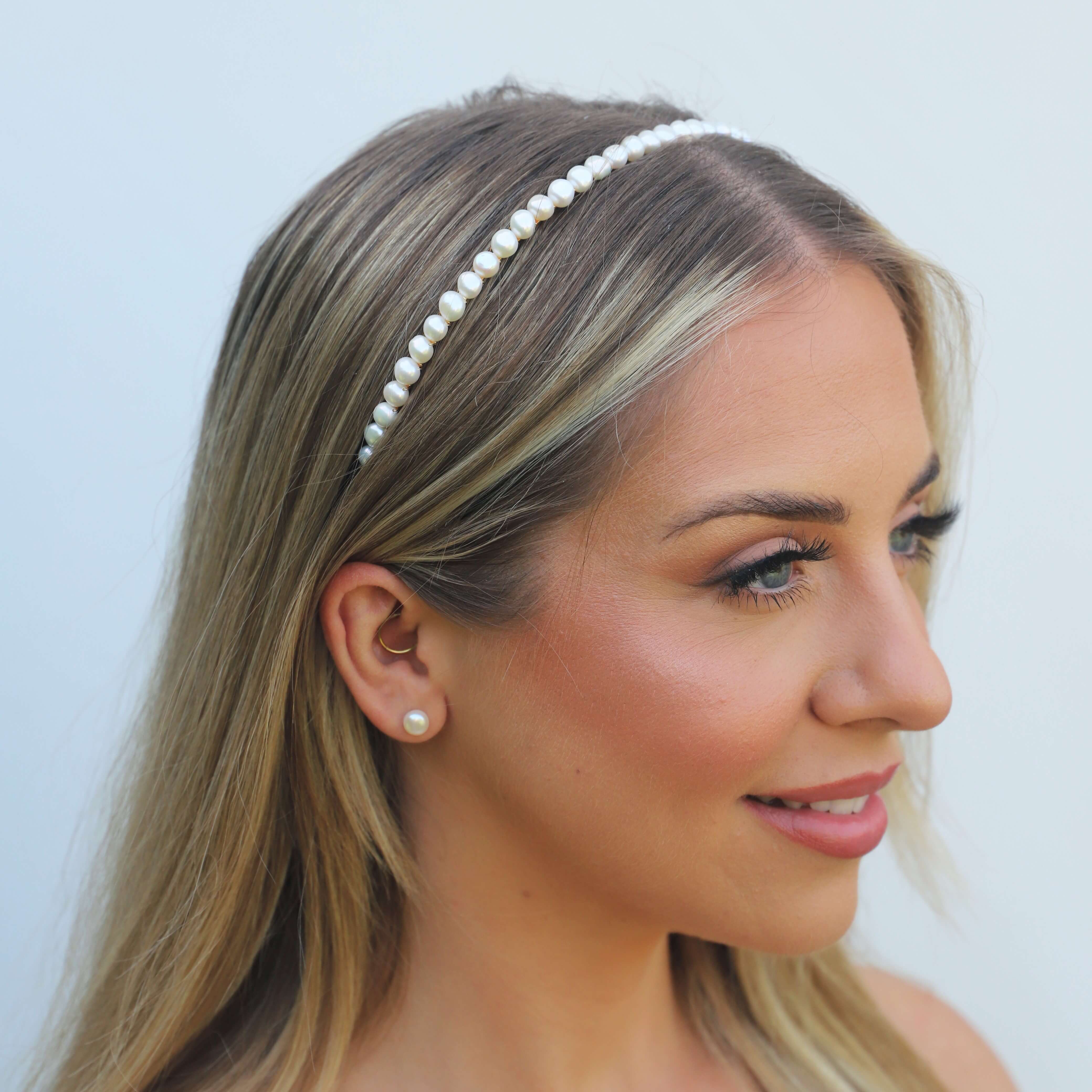 Headshot of model wearing a pearl metal headband