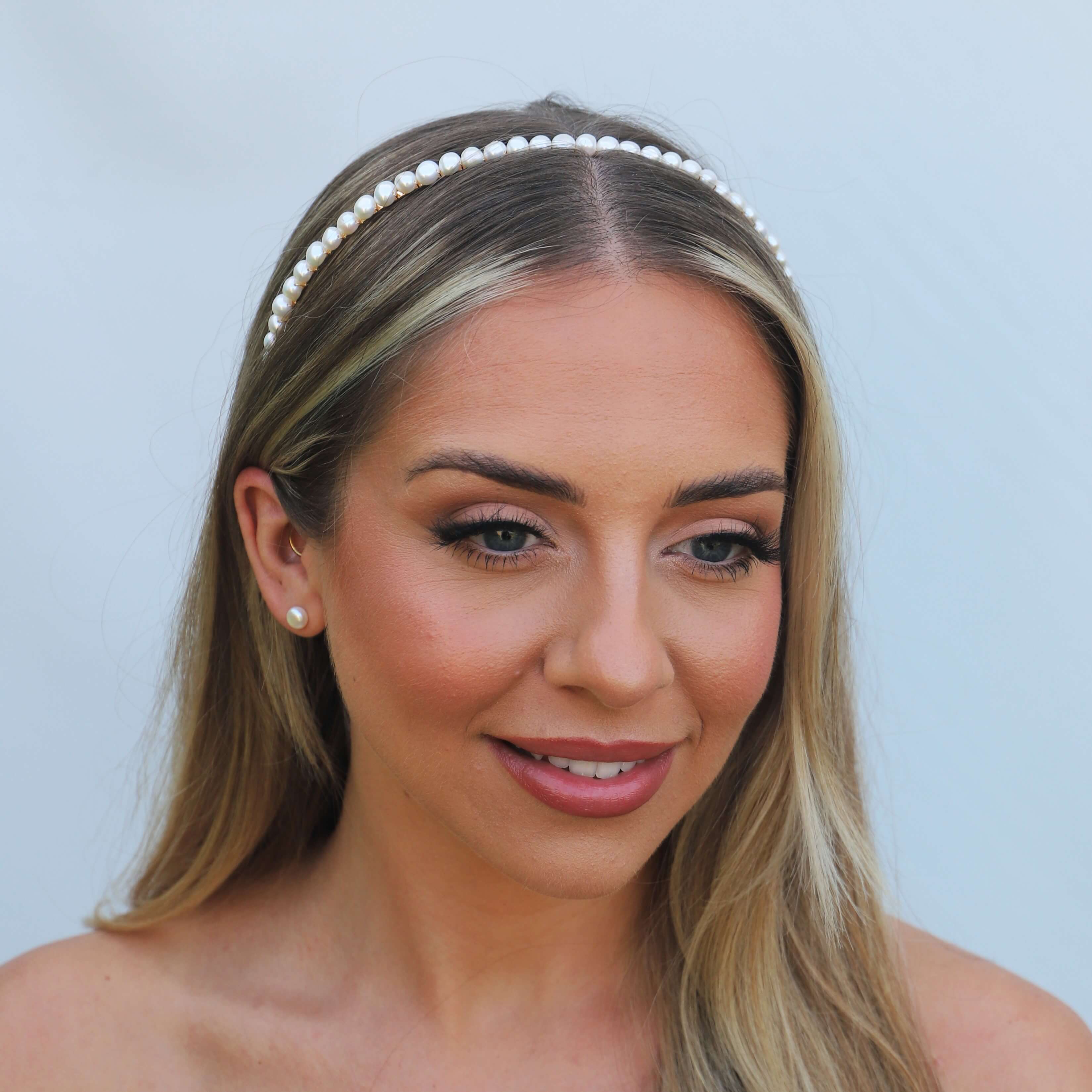 Front view of model wearing a pearl metal headband