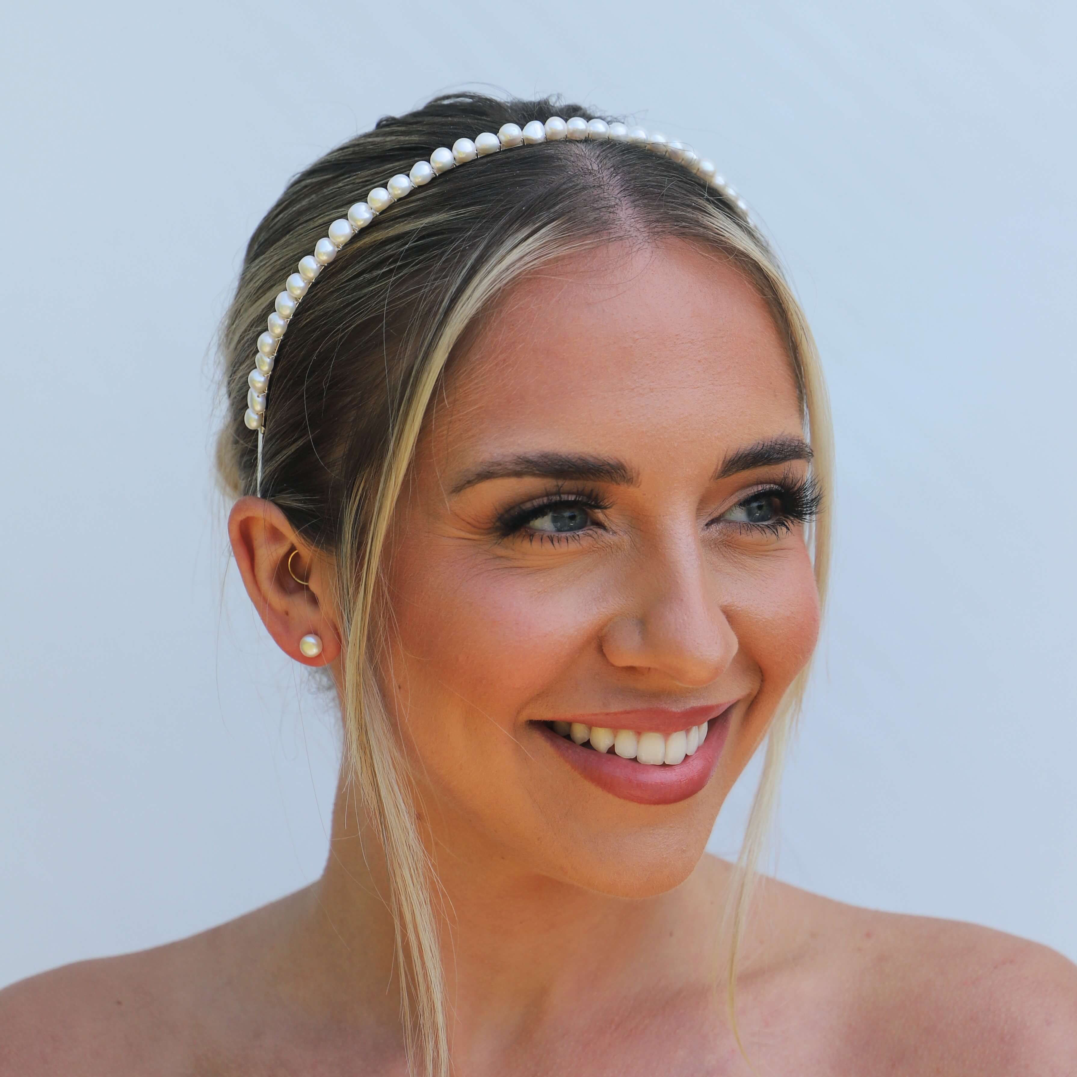 Happy bride wearing a white freshwater pearl headband