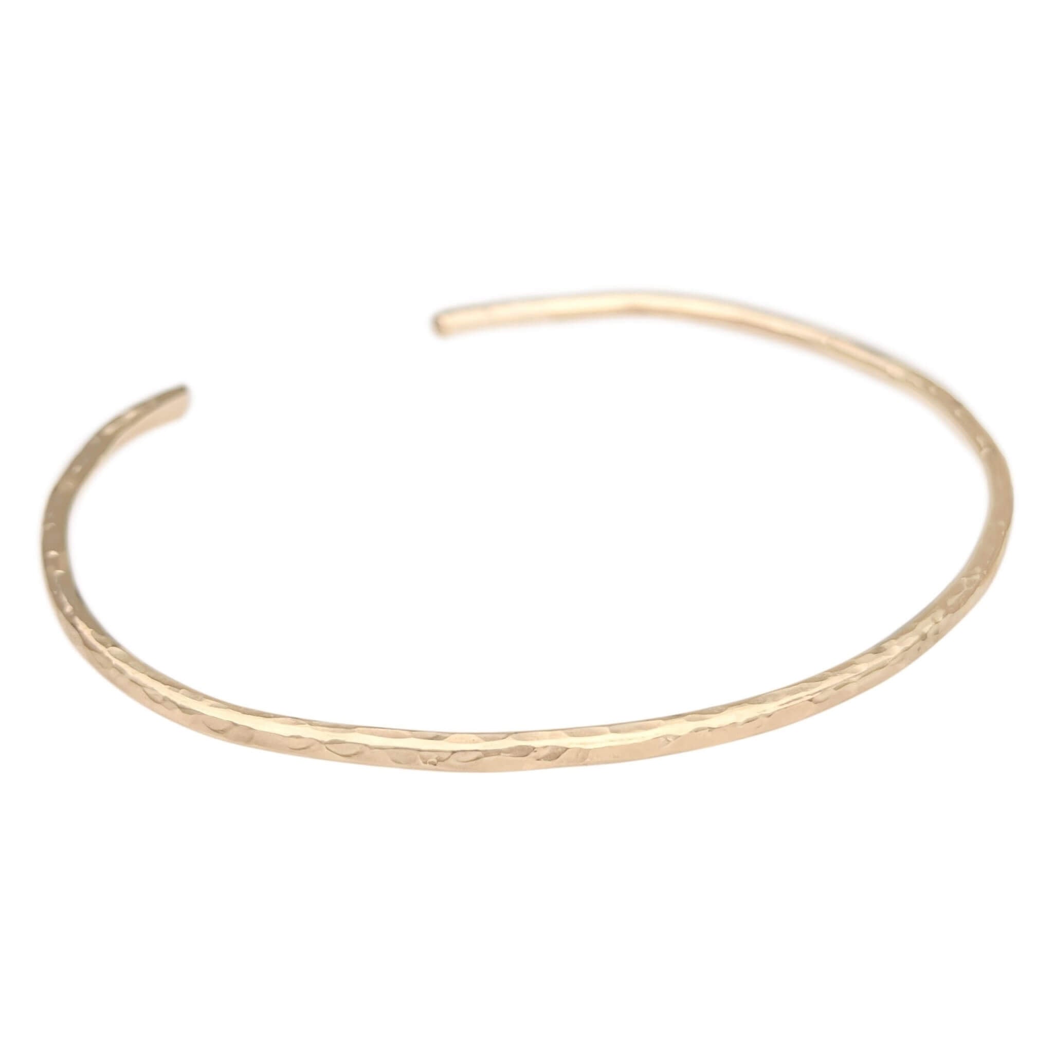 hammered cuff bracelet in gold filled on a white background