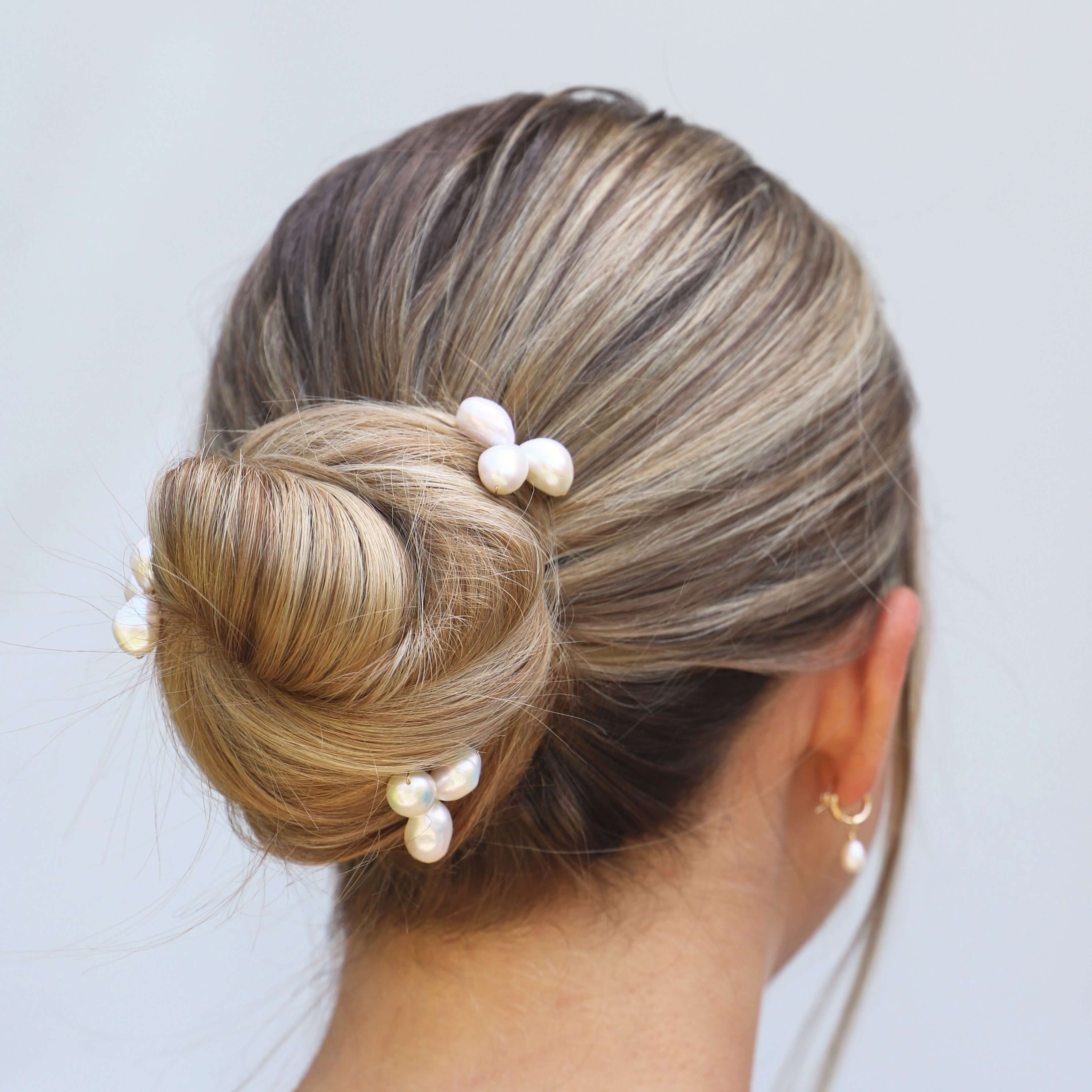 large pearl cluster hair pins on wedding model close up