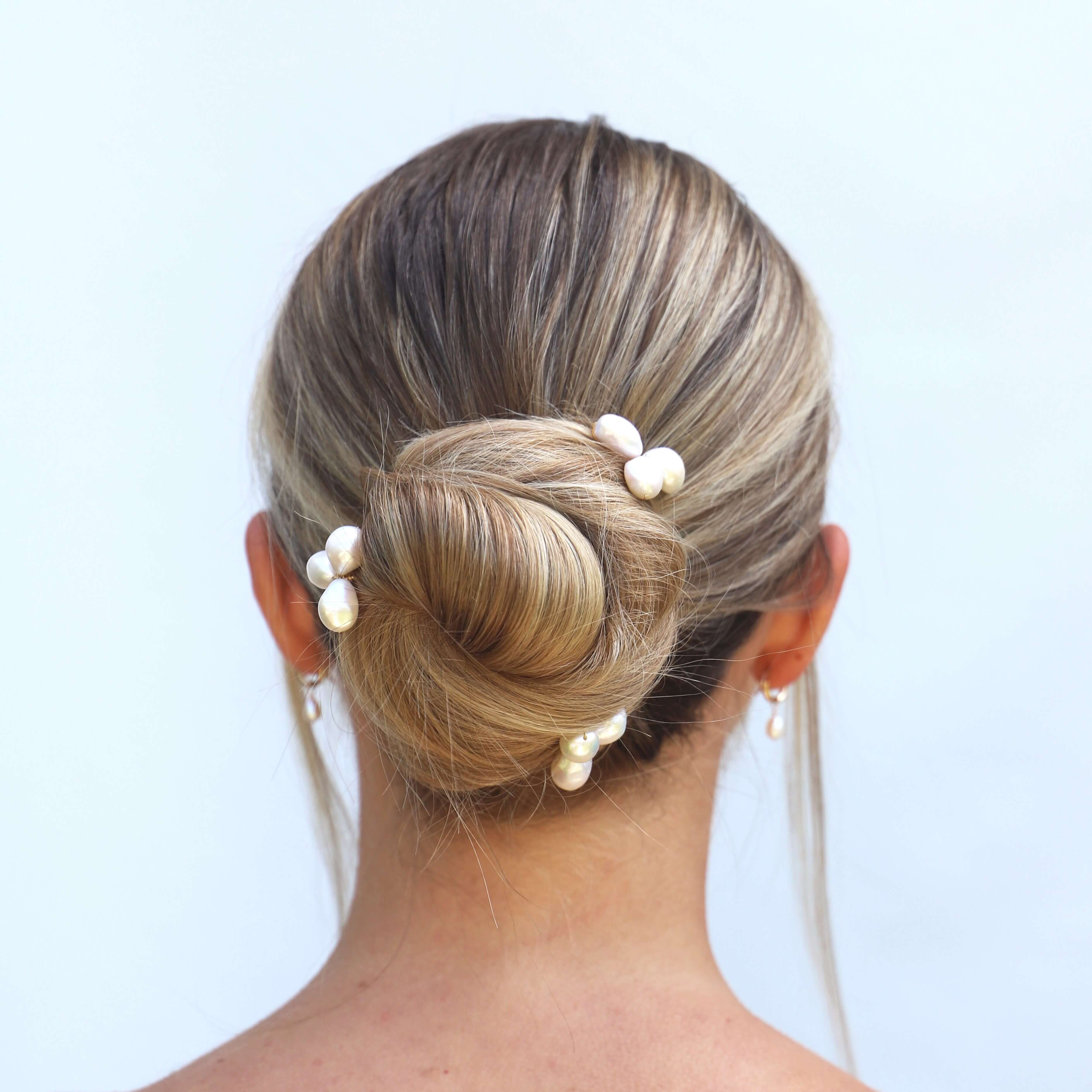 large pearl cluster hair pins in hair on bride