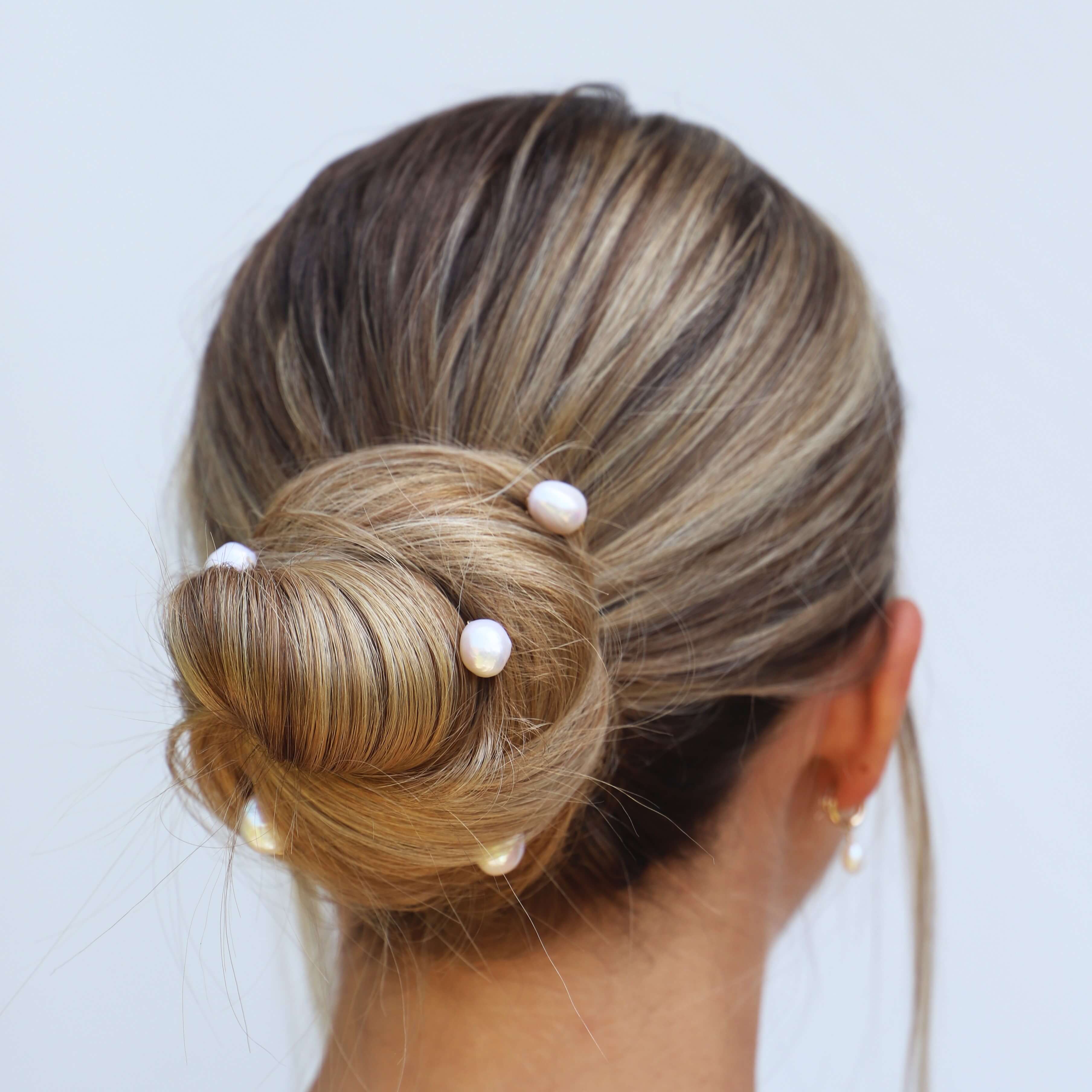 bride wearing large real pearl hair pins