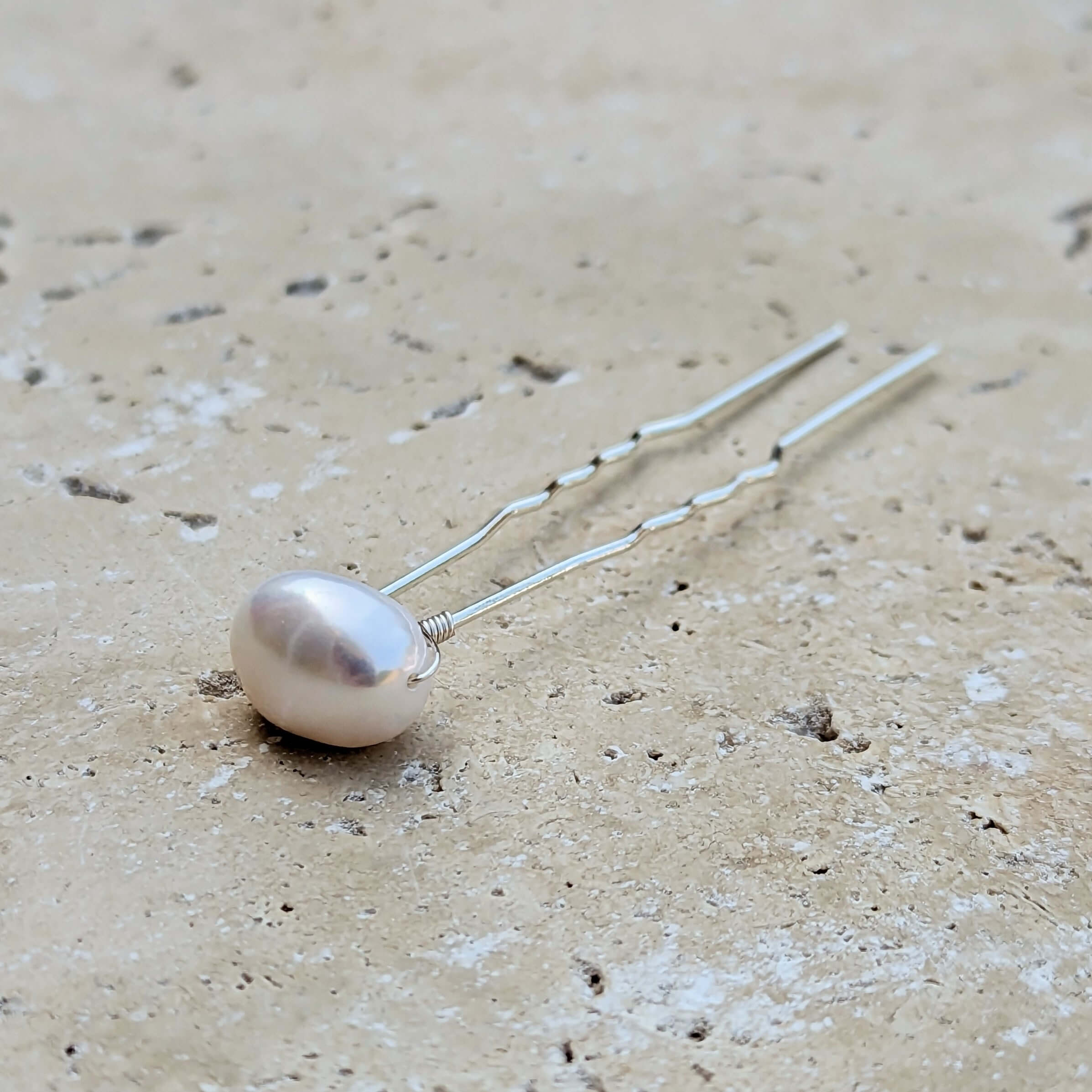 One large baroque pearl on a silver hair pin