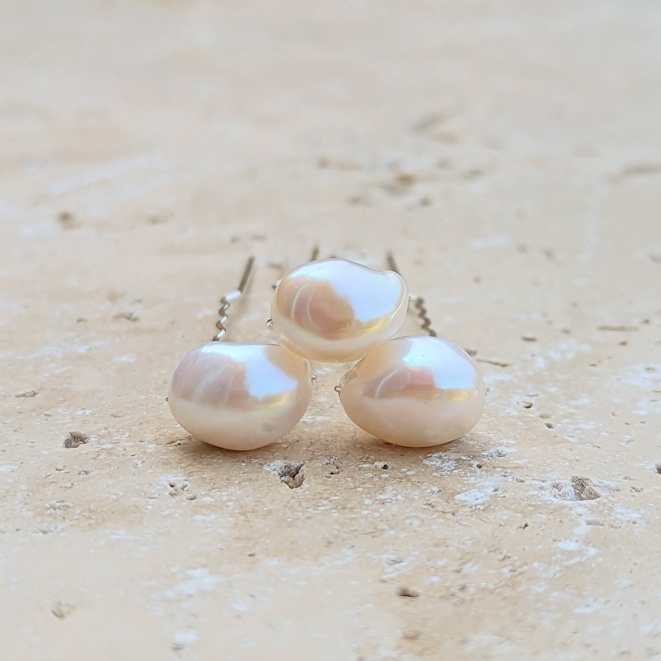 Three large white real pearls on silver hair pins