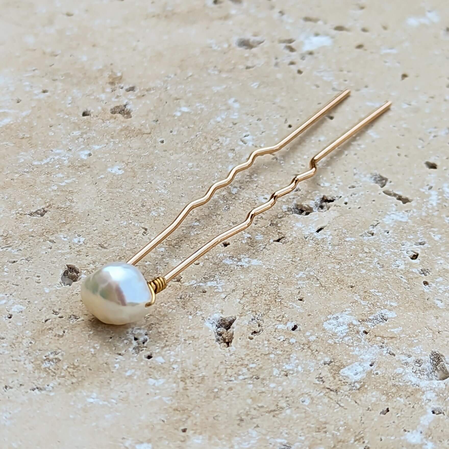 Single mid sized real baroque pearl on gold coloured hair pin