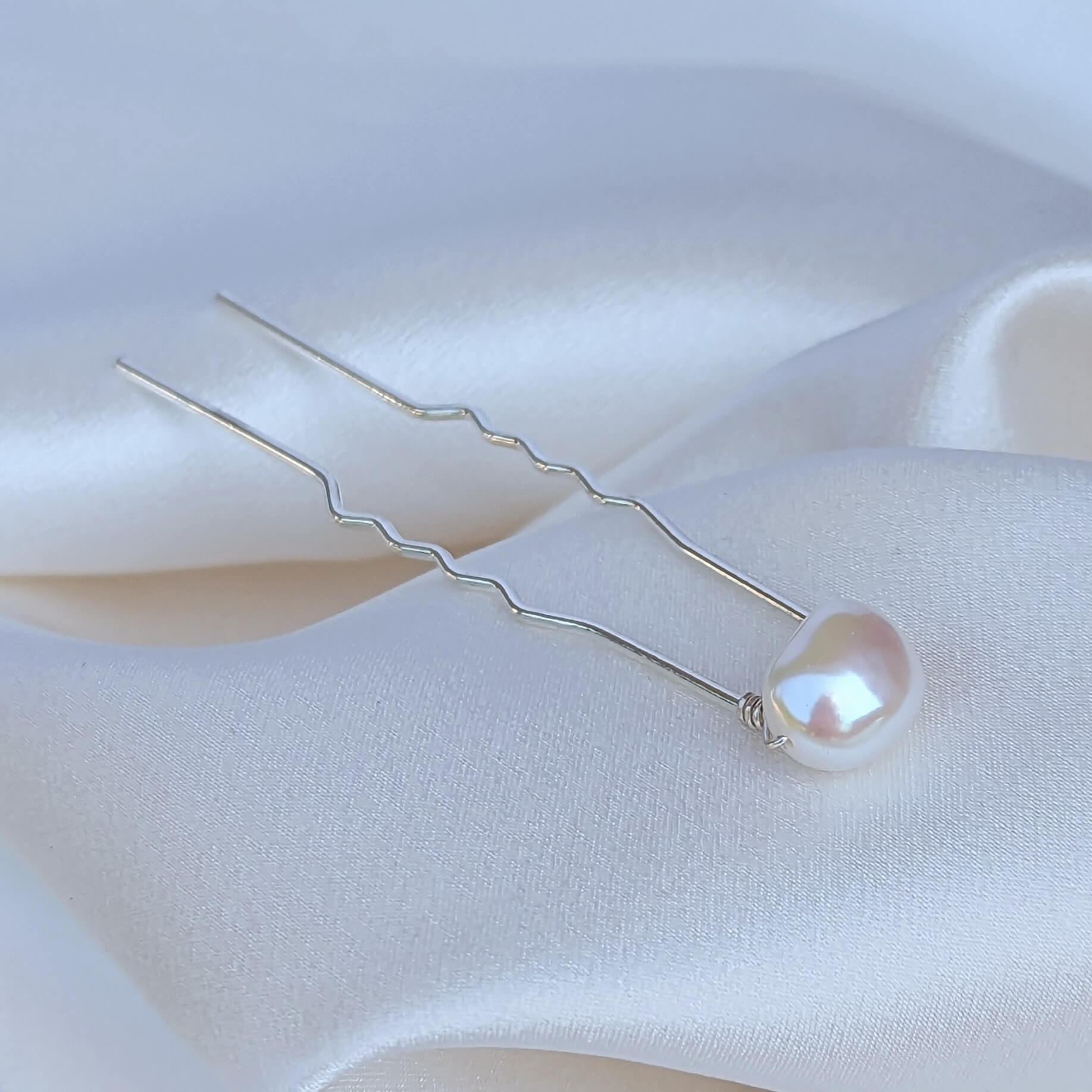 a medium sized real freshwater pearl on silver coloured hair pin