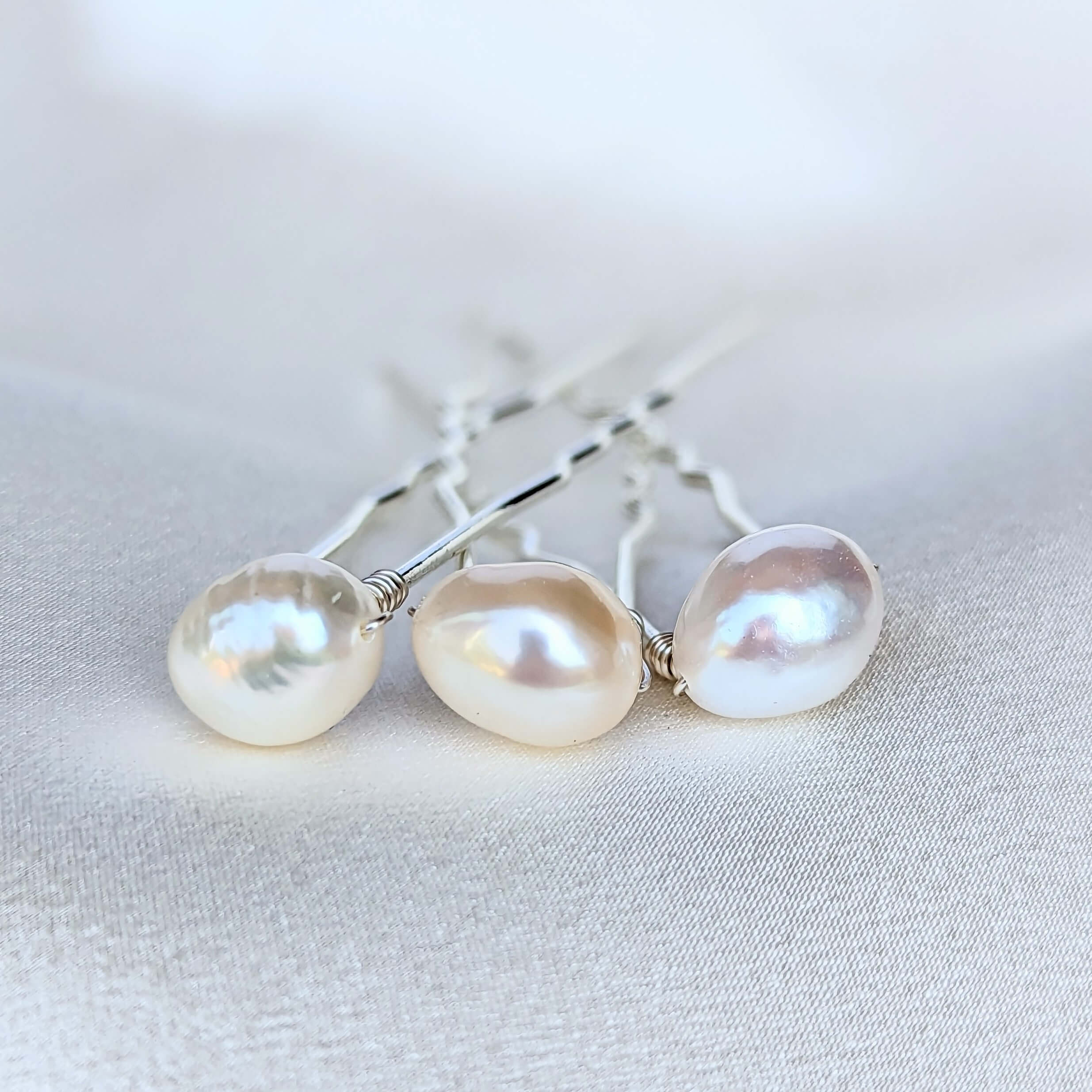 set of three medium sized real freshwater pearls on silver coloured hair pins