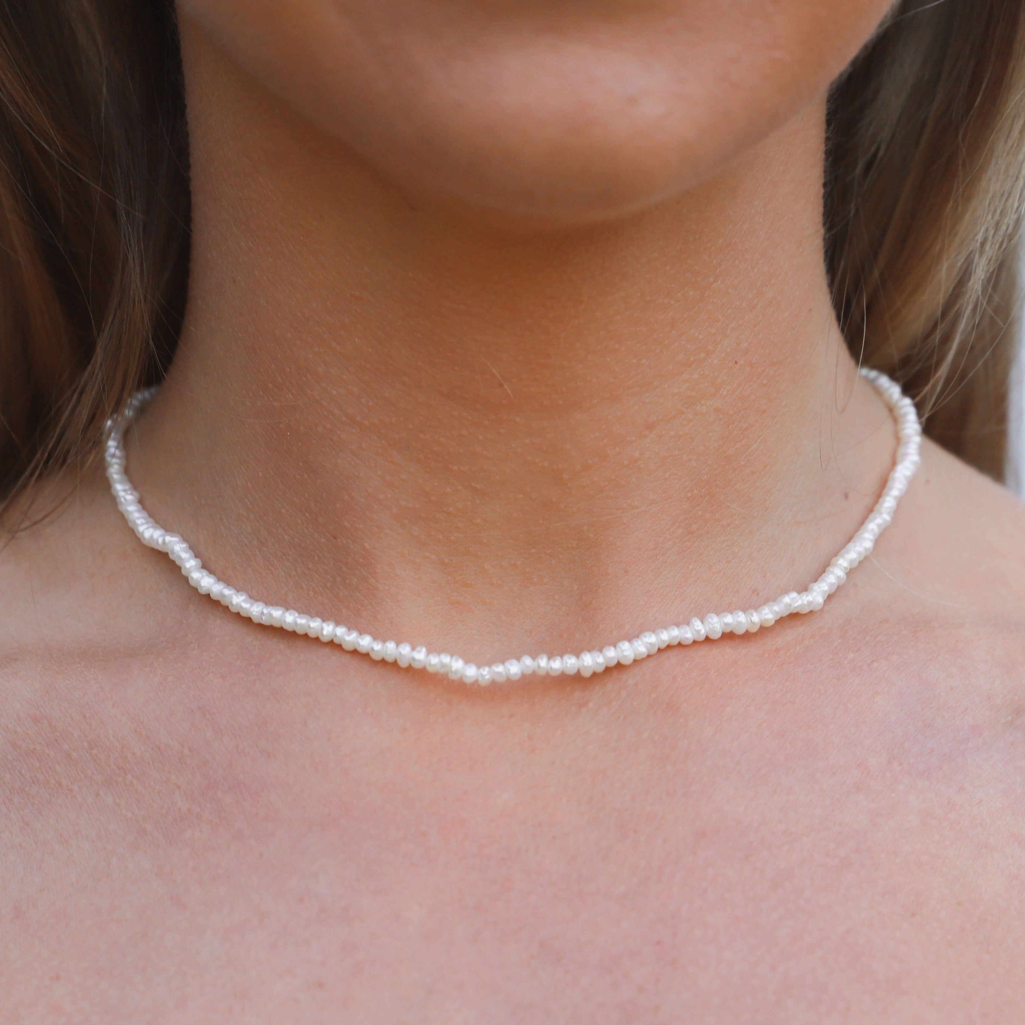 mini freshwater pearl necklace close up on model