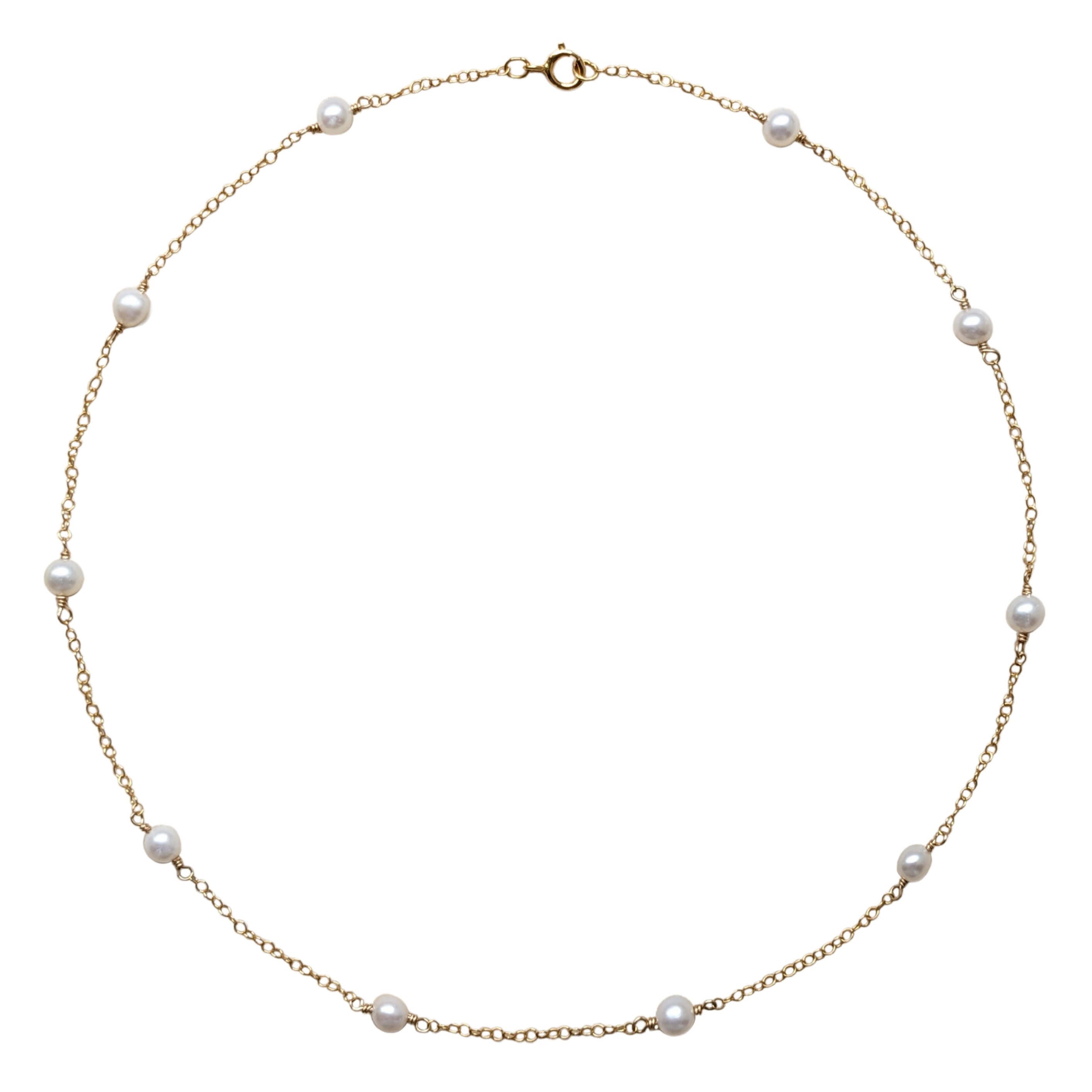 pearl and gold filled chain necklace on a white background