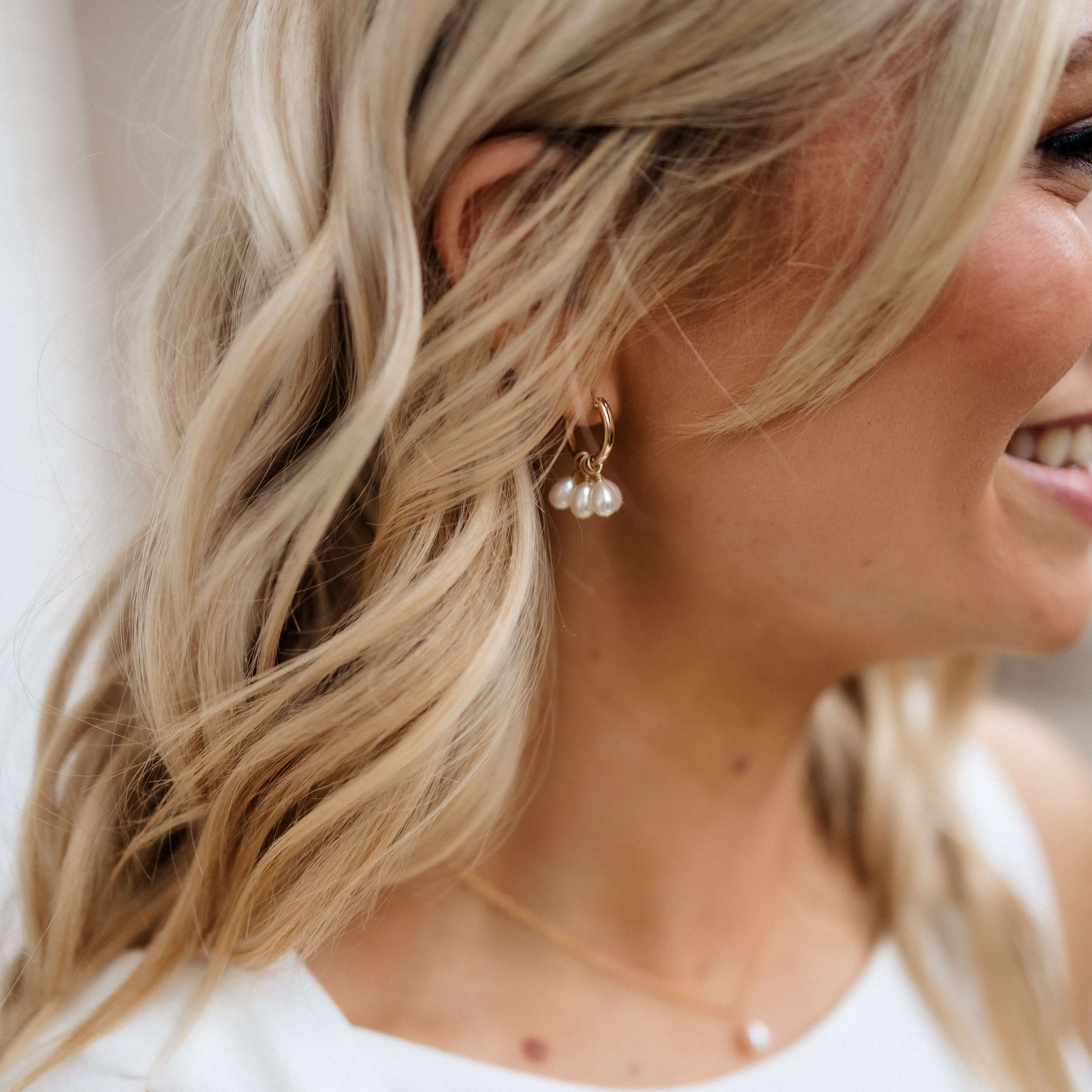 pearl cluster hoop earrings on model close up