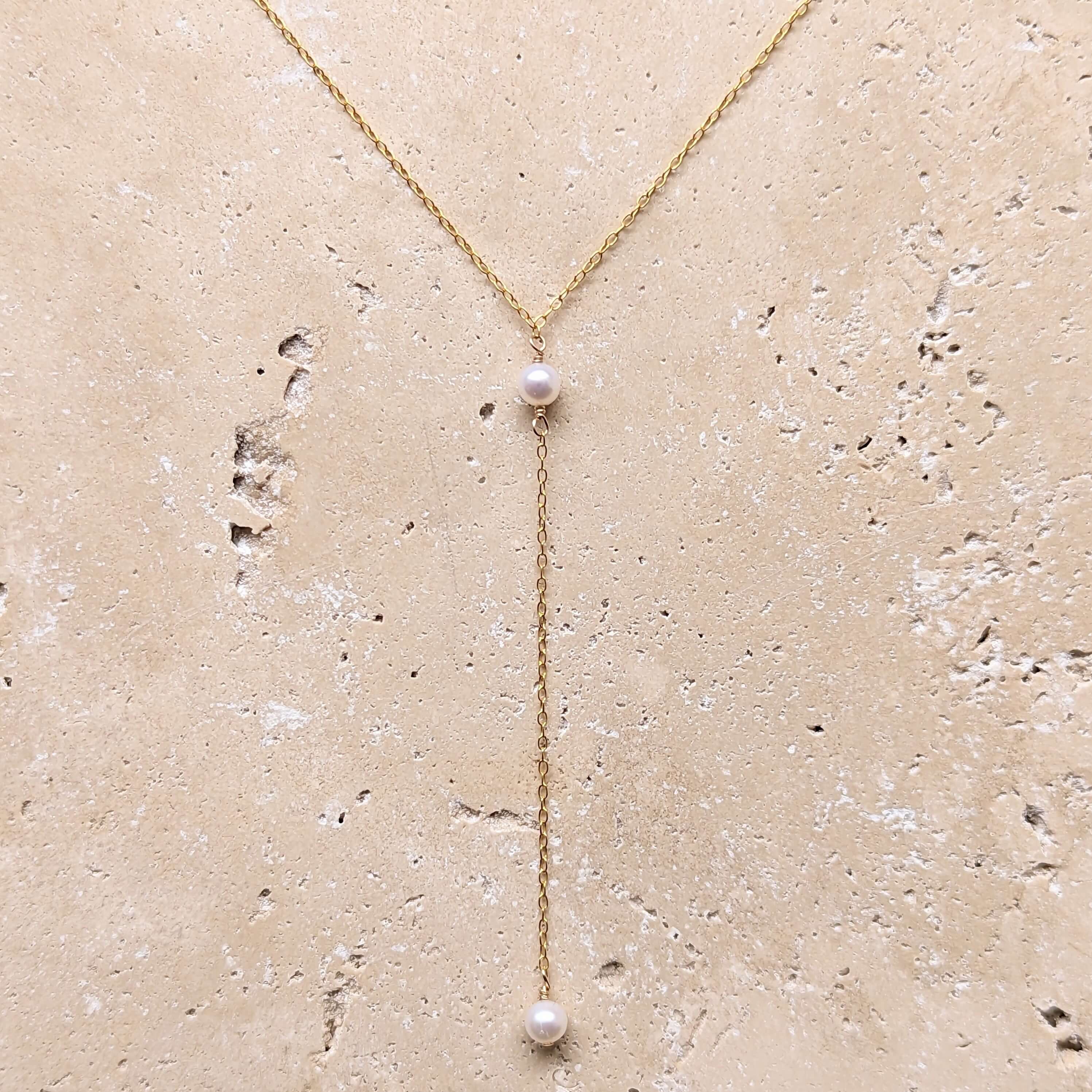 gold filled pearl lariat necklace flatlay
