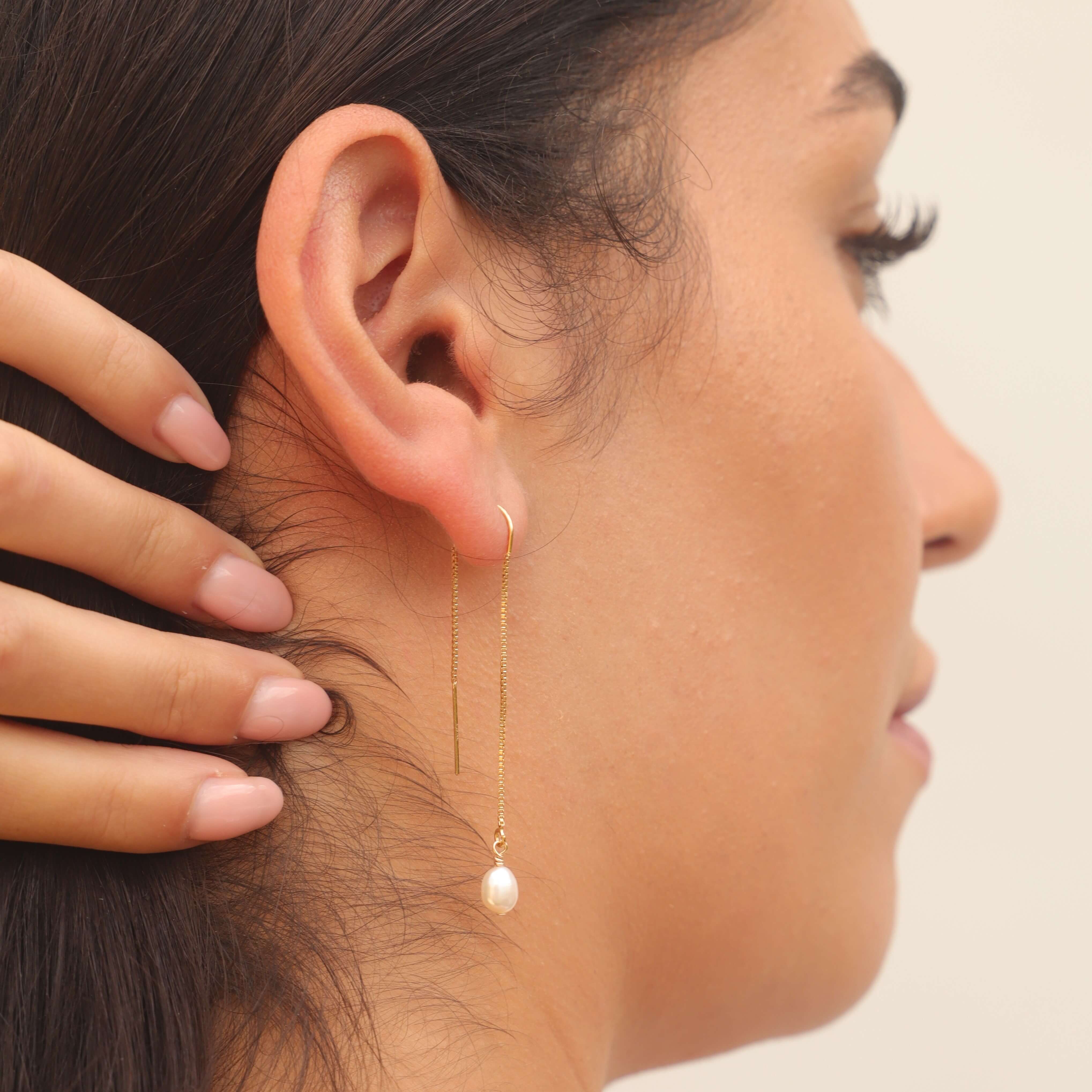 pearl threader earrings in gold filled on model close up