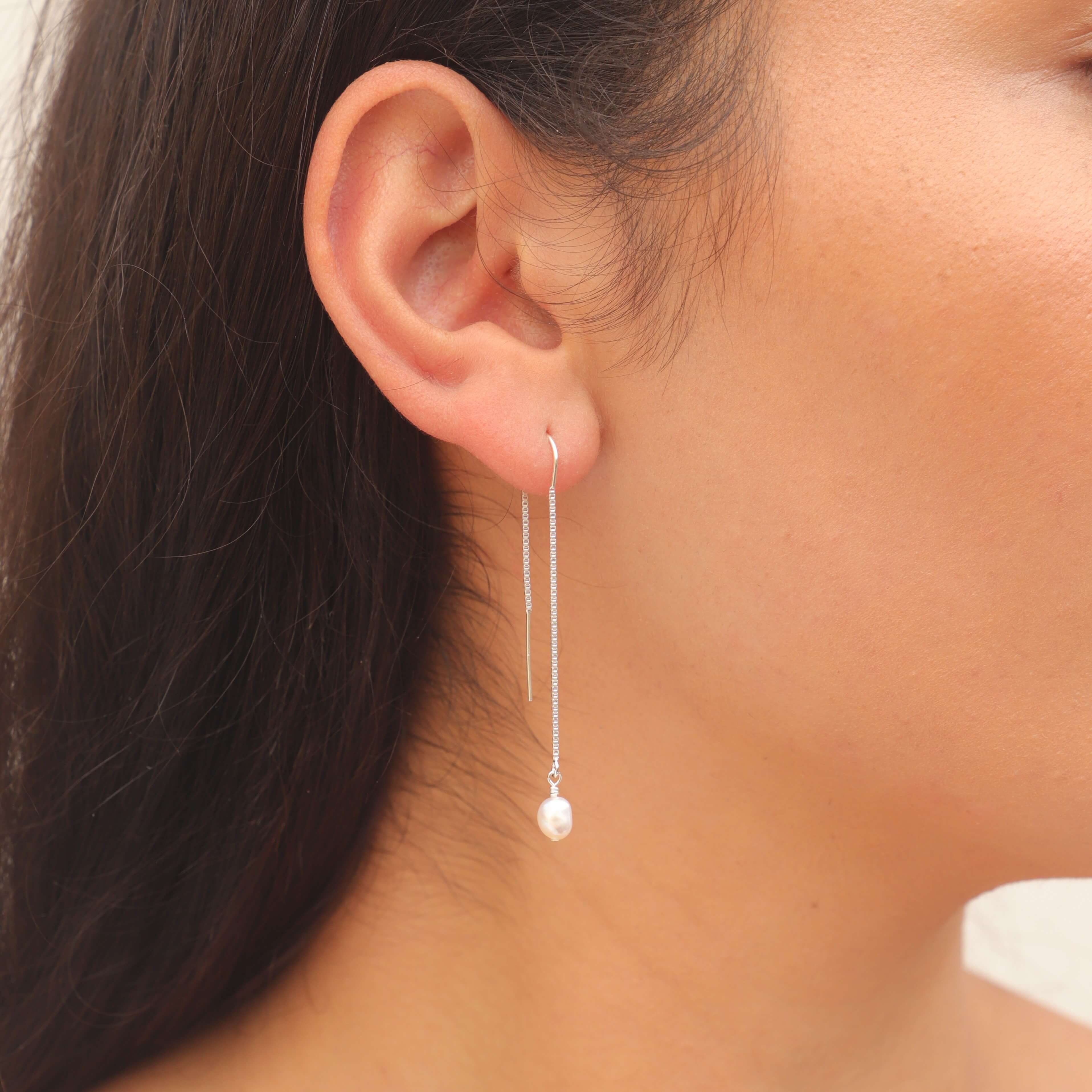 pearl threader earrings in sterling silver on model close up
