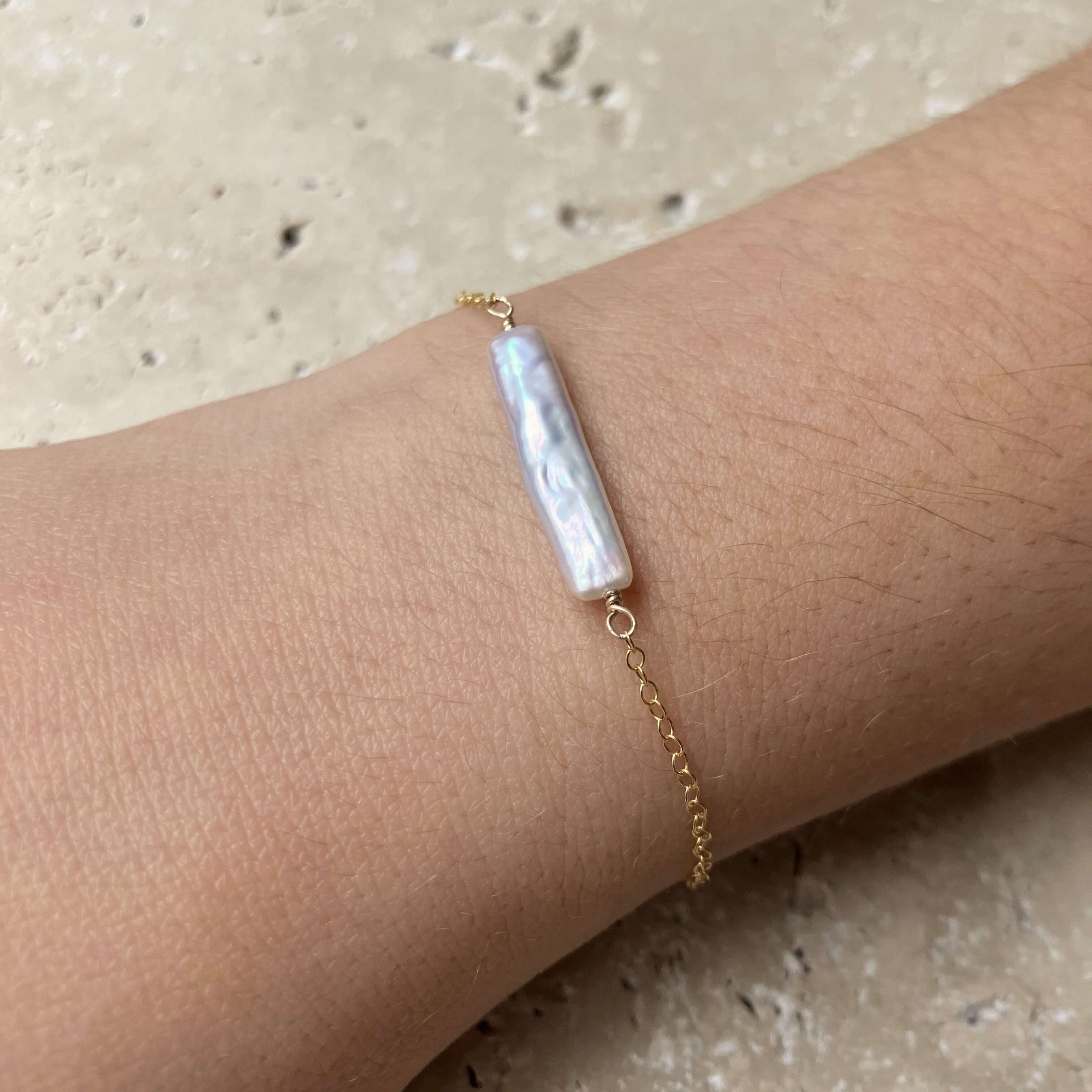 pearl bar bracelet on model wrist in gold filled
