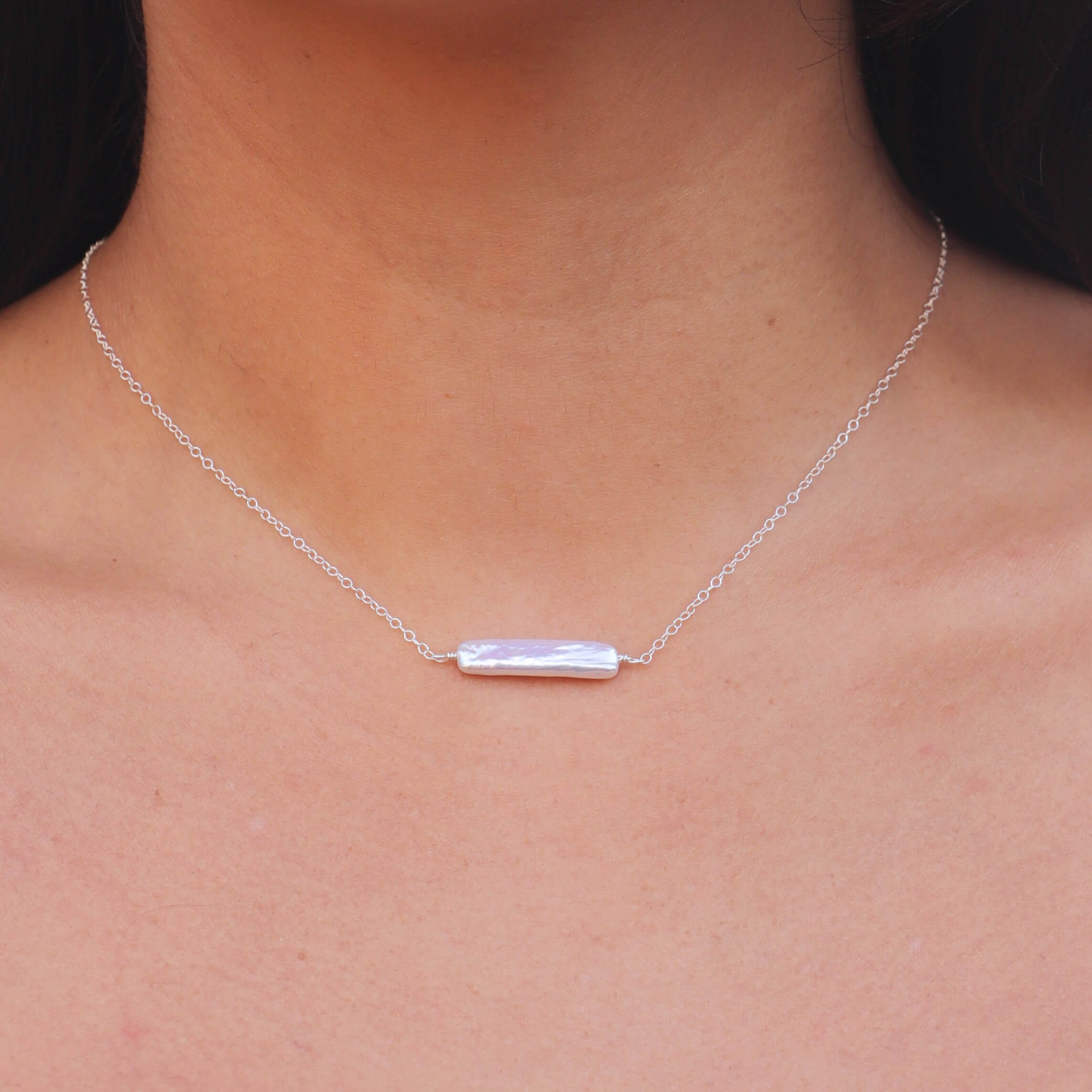 Neck of model with rectangular pearl sterling silver necklace