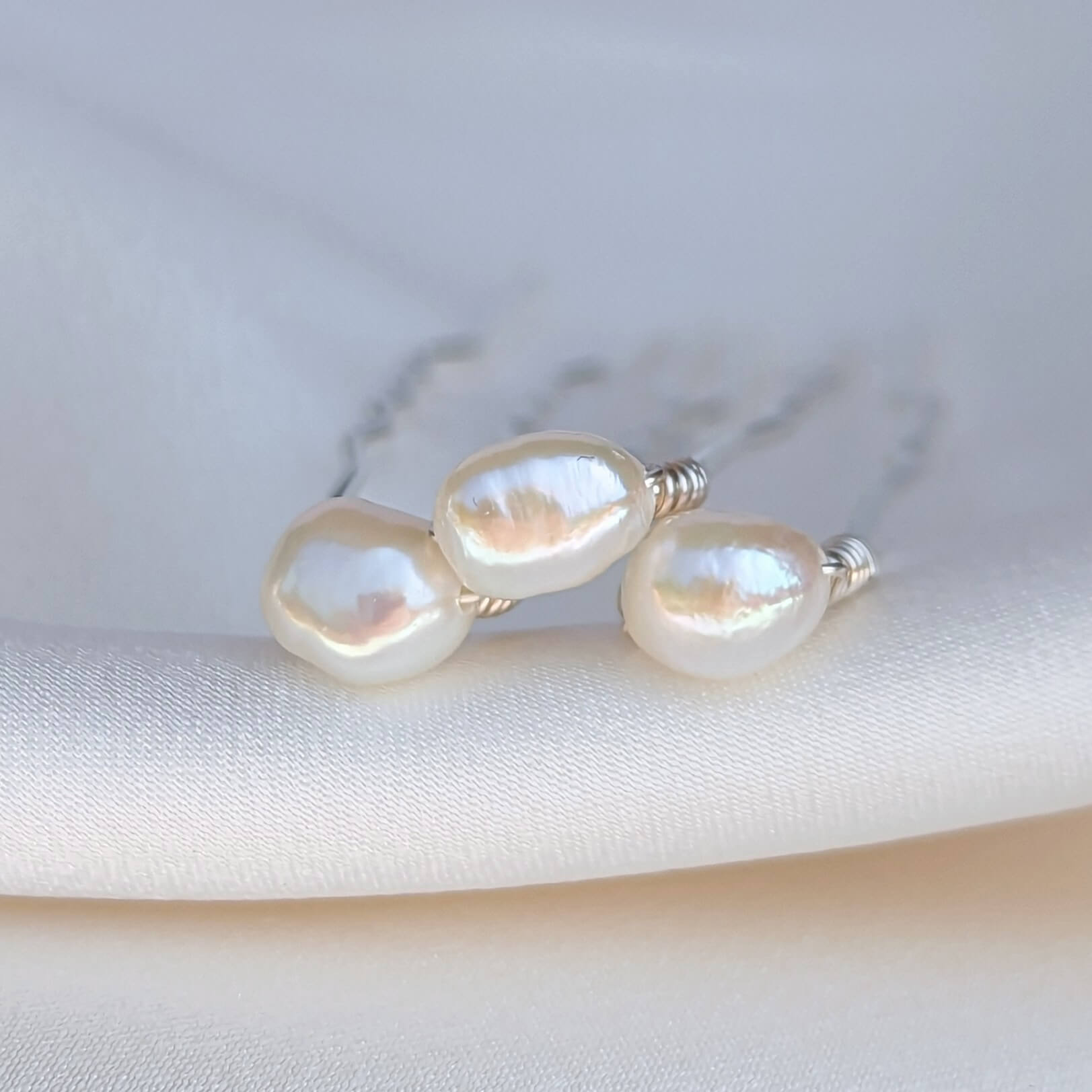 three small pearl hair pins in silver