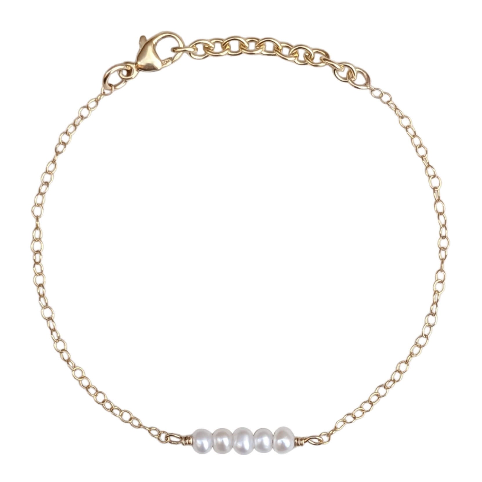 tiny pearl bar bracelet in gold filled on a white background