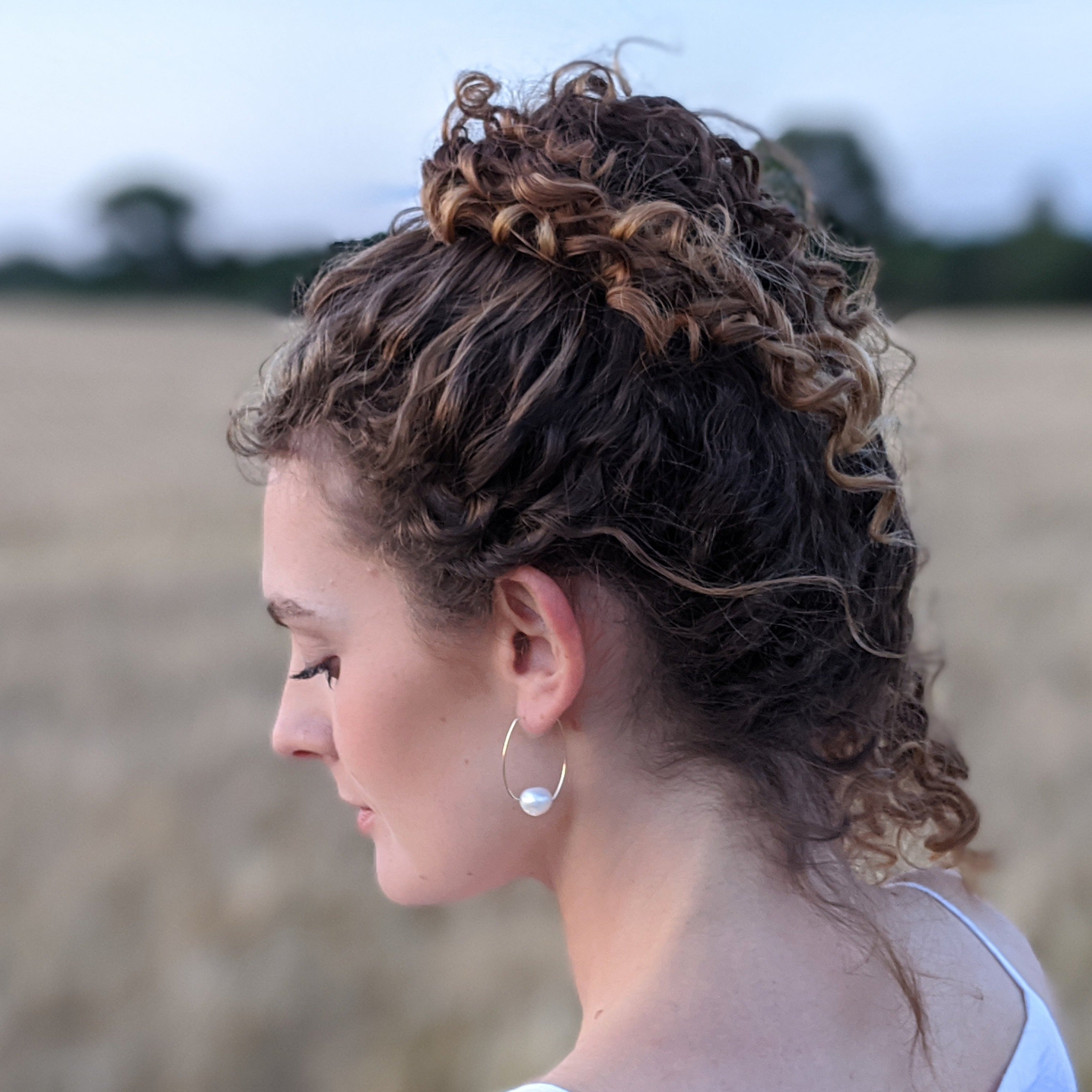 curly hair bun large pearl hoop earring