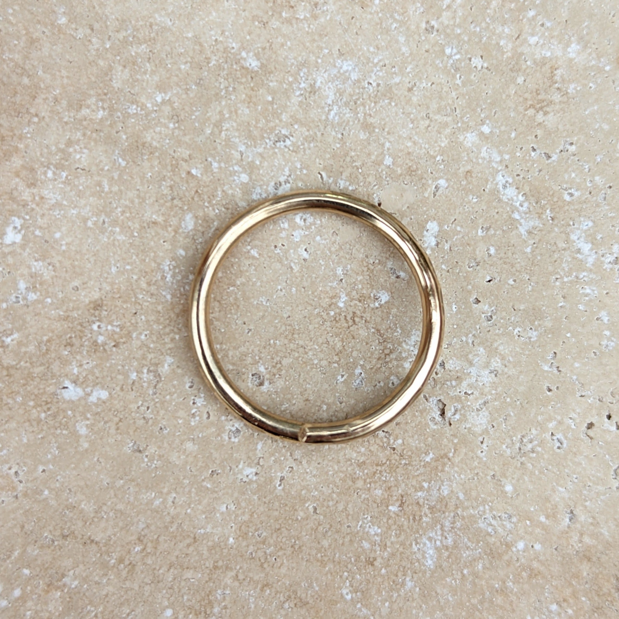 Gold ring from above on tile