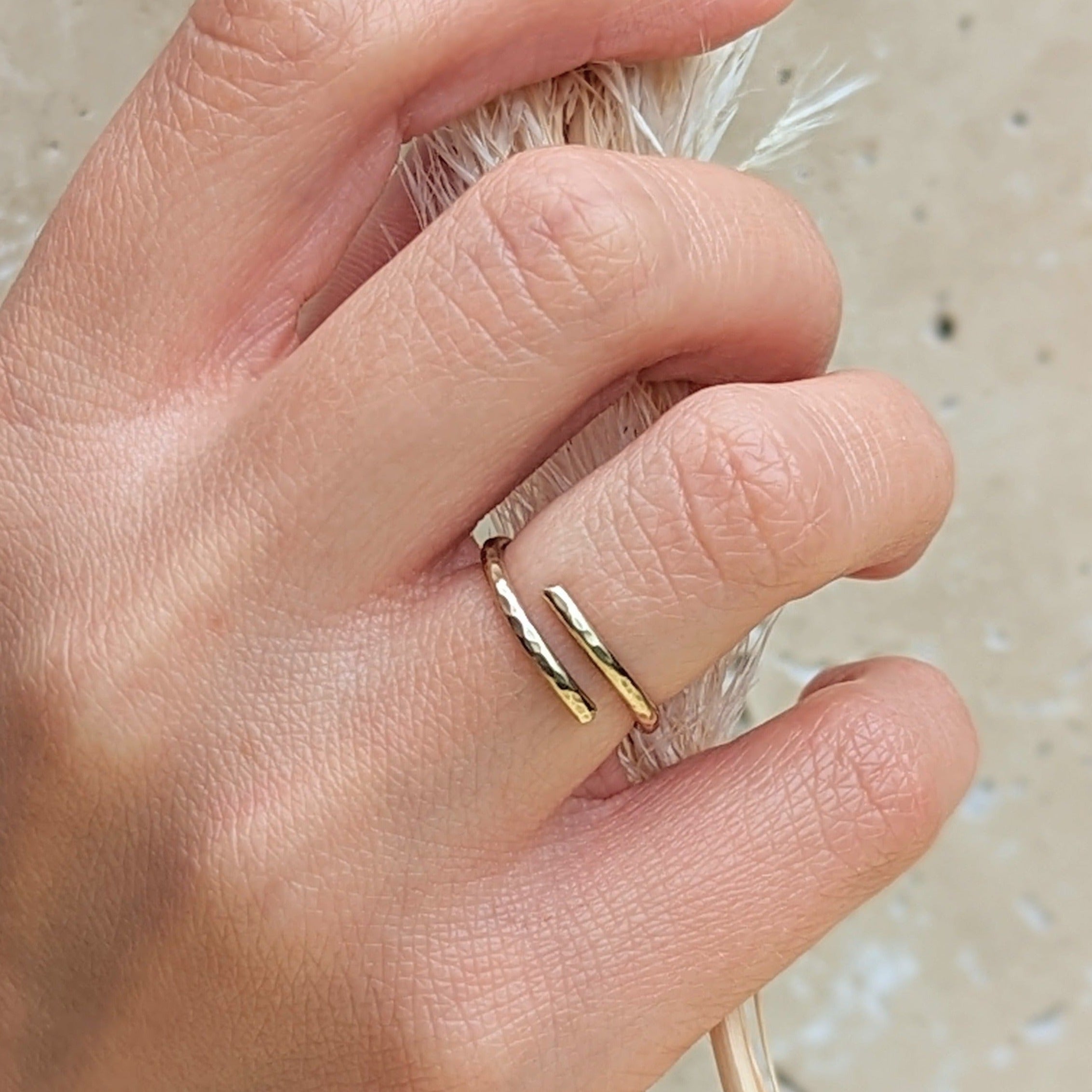 hand holding dried floral and wearing adjustable hammered gold ring