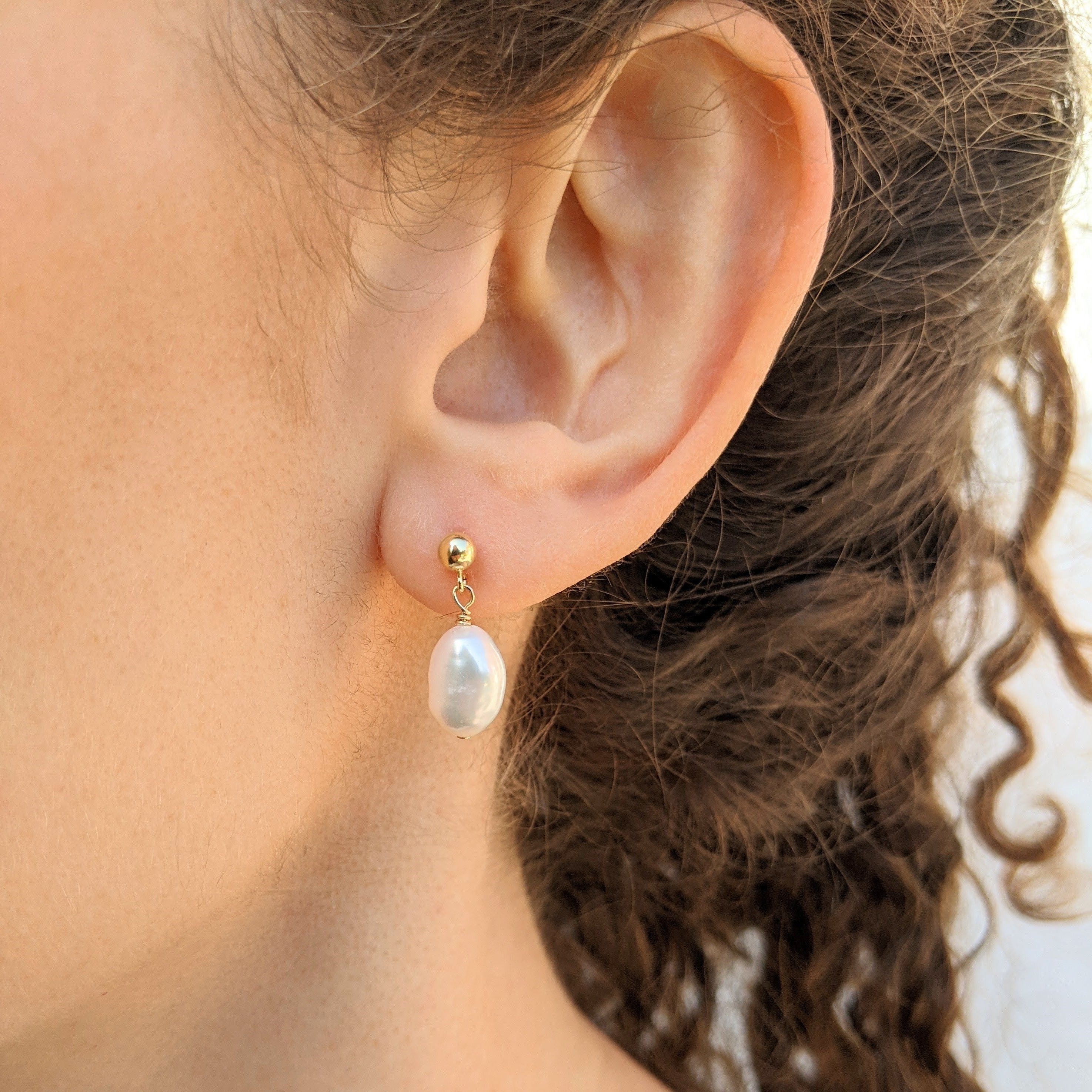 Ball stud single baroque pearl drop earrings model closeup