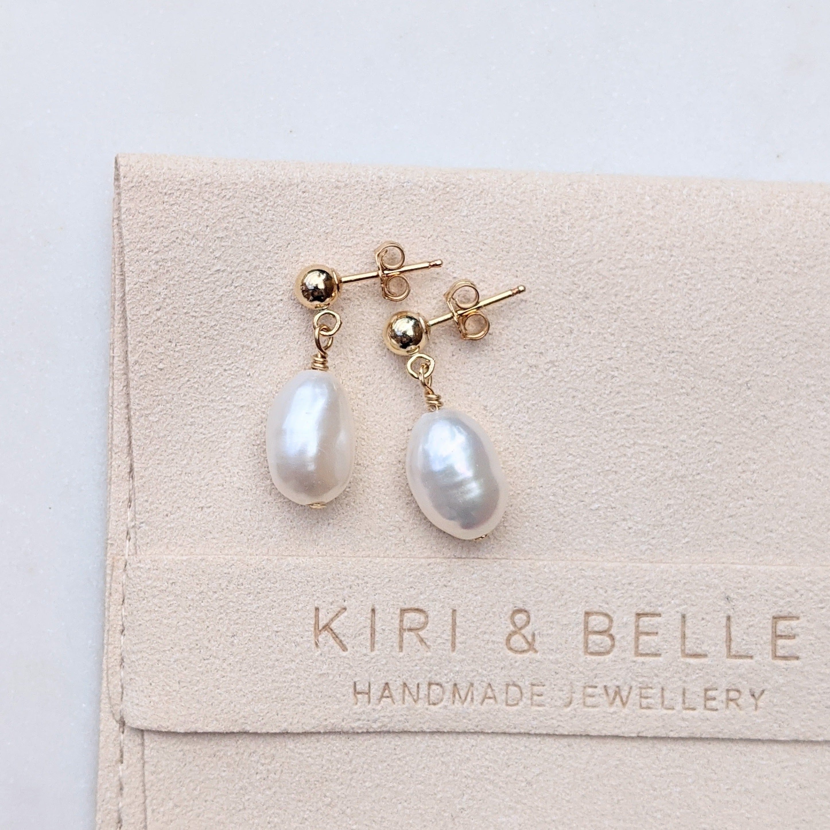Ball stud single baroque pearl drop earrings