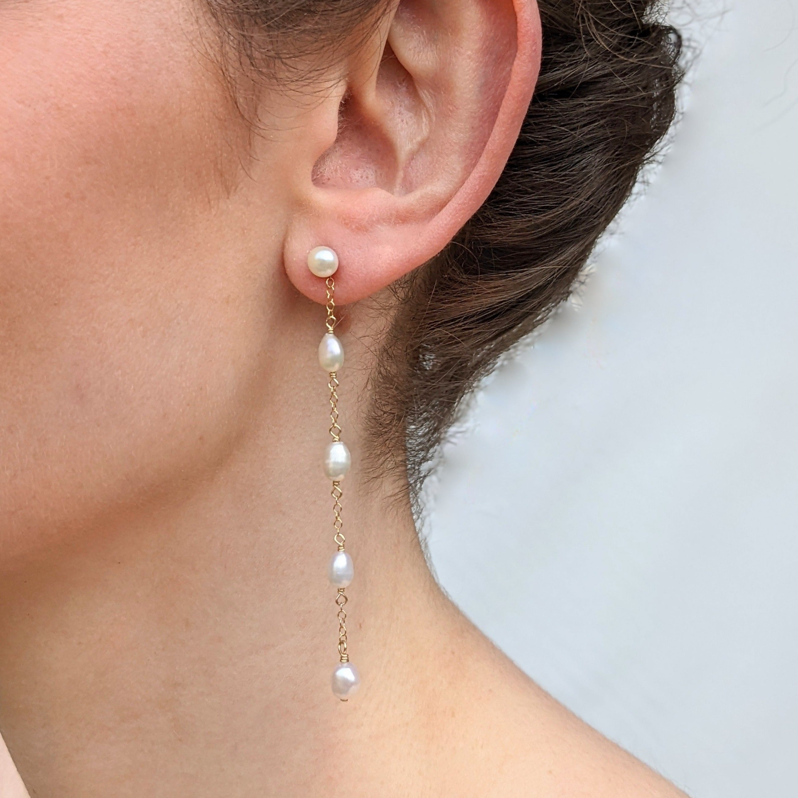 Dainty long pearl earrings stud dangle emilie gold closeup