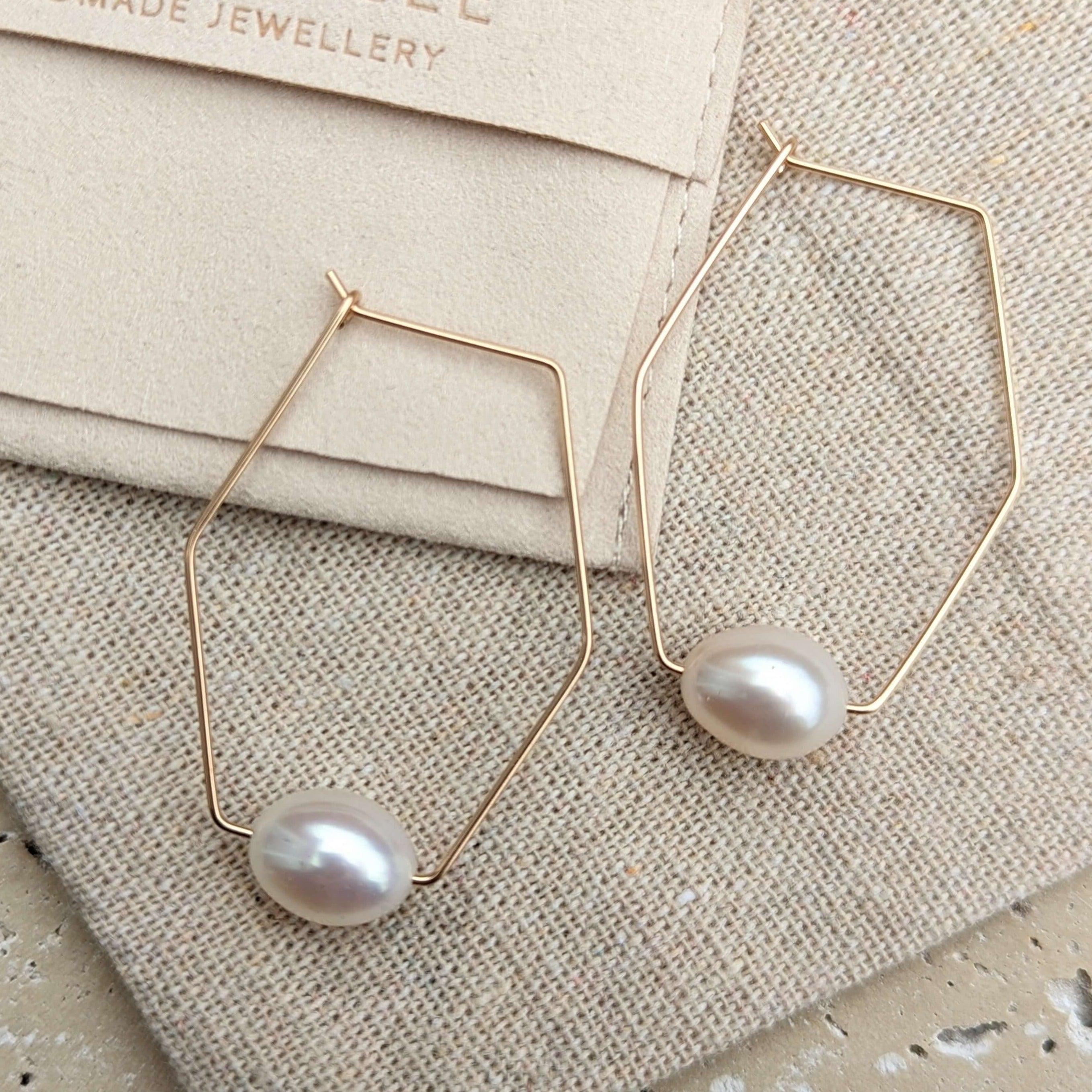 geometric pearl earrings in gold filled flatlay