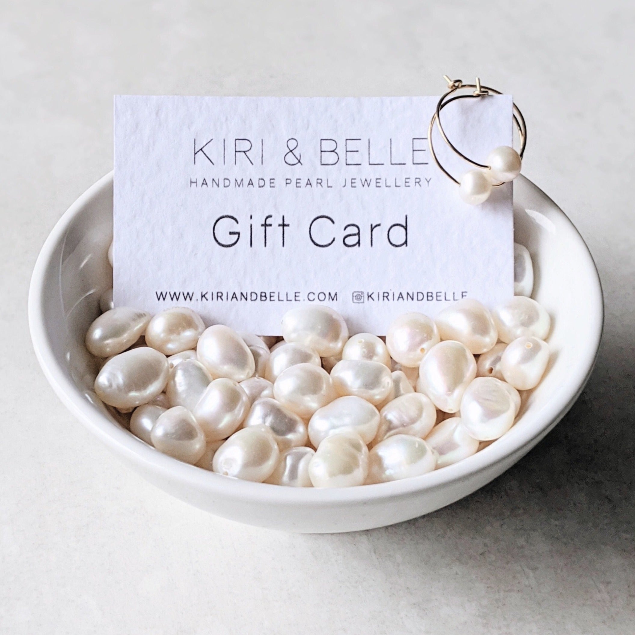 Gift card in bowl of white large baroque pearls