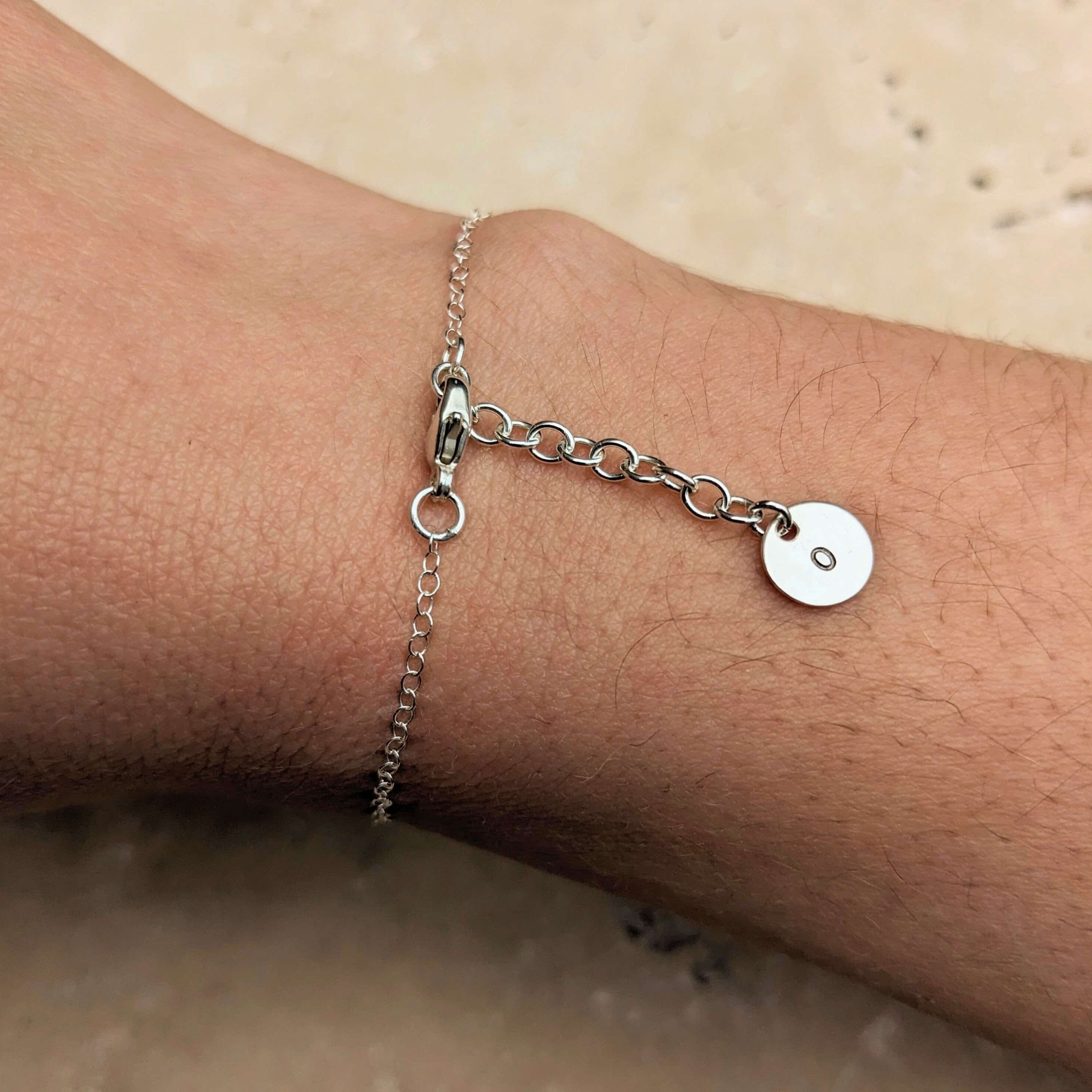 silver disc charm bracelet on model