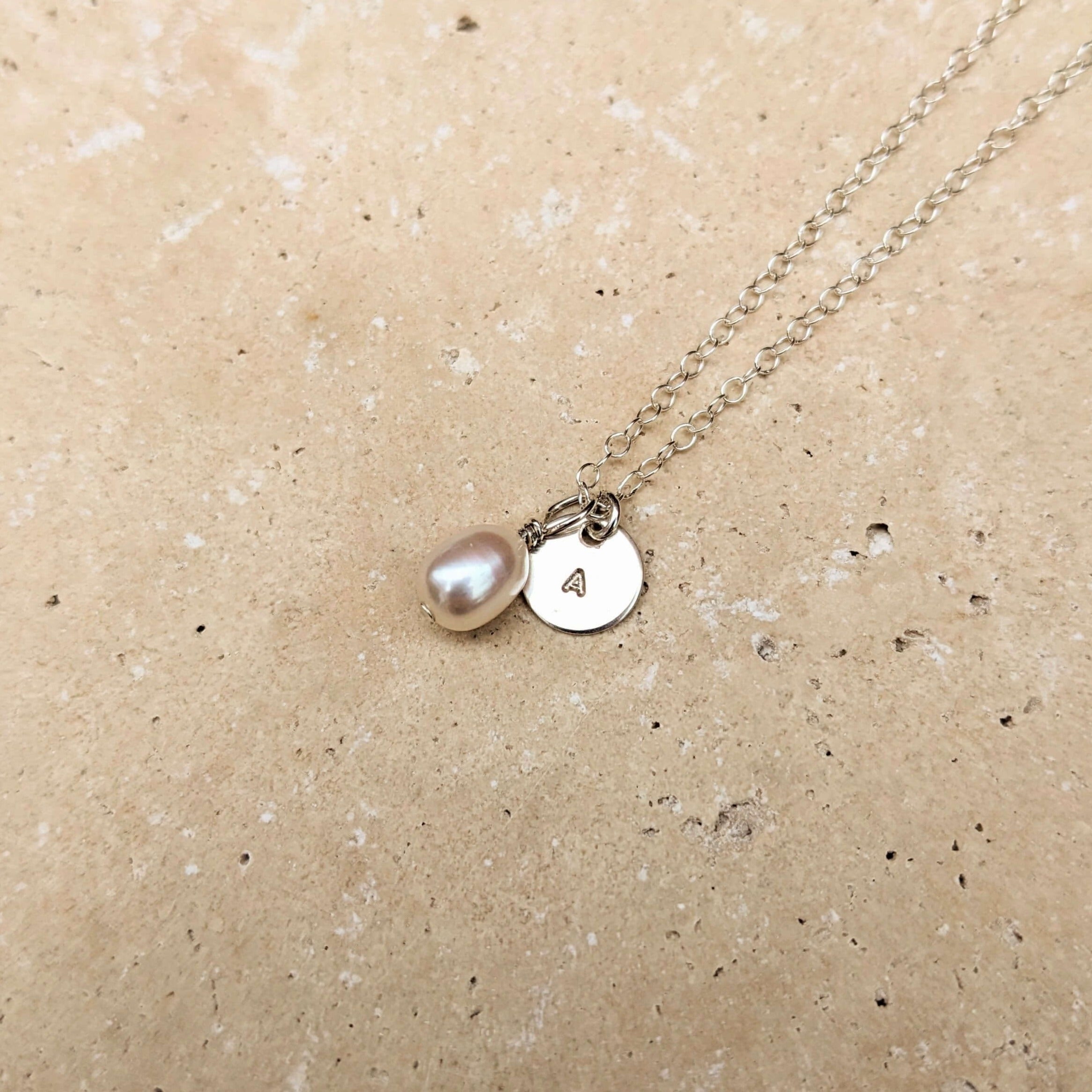initial disc charm on silver pearl necklace