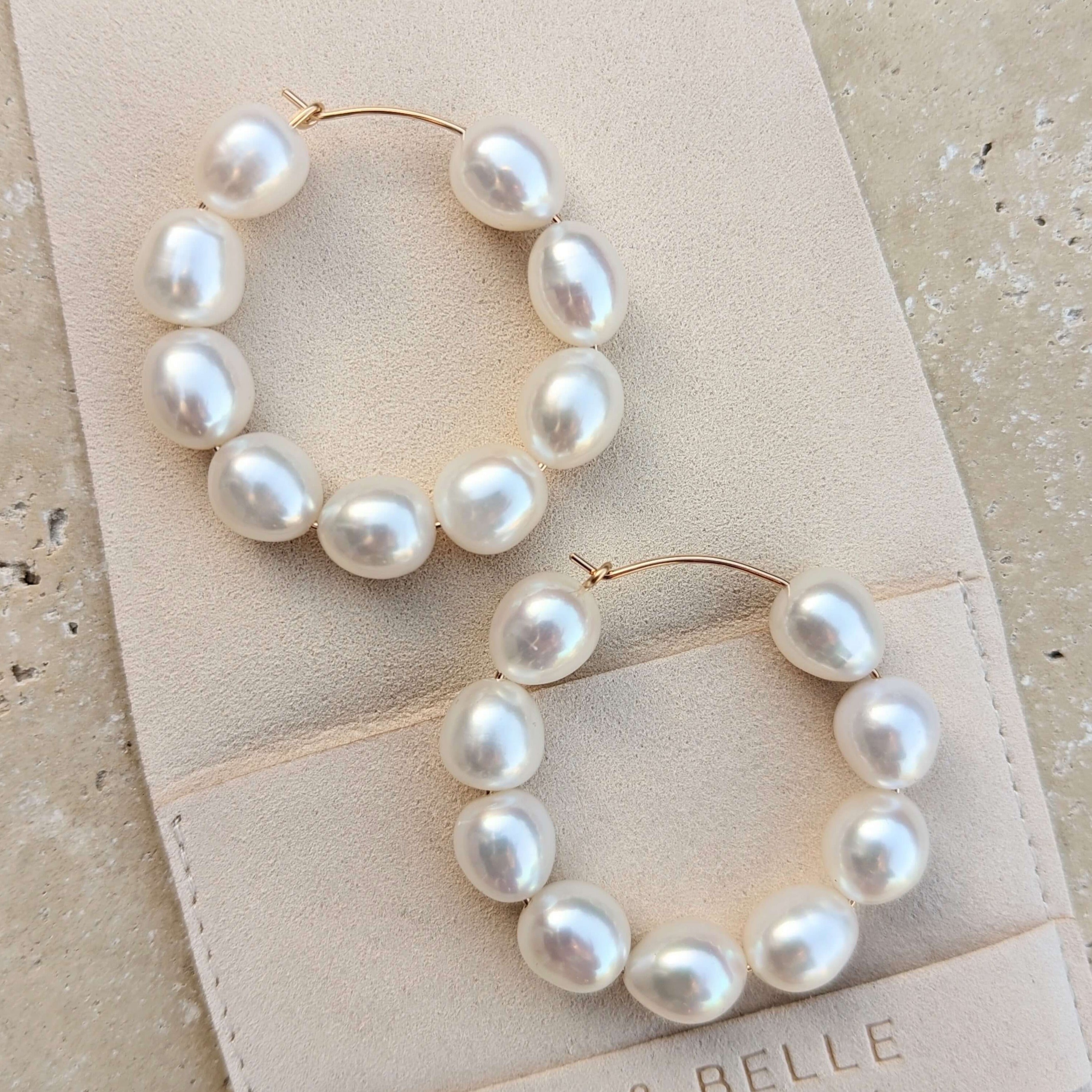 large pearl hoop earrings in gold filled on suede pouch