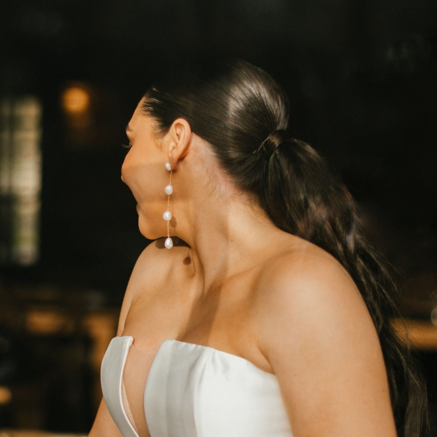 long pearl drop earrings on bridal model