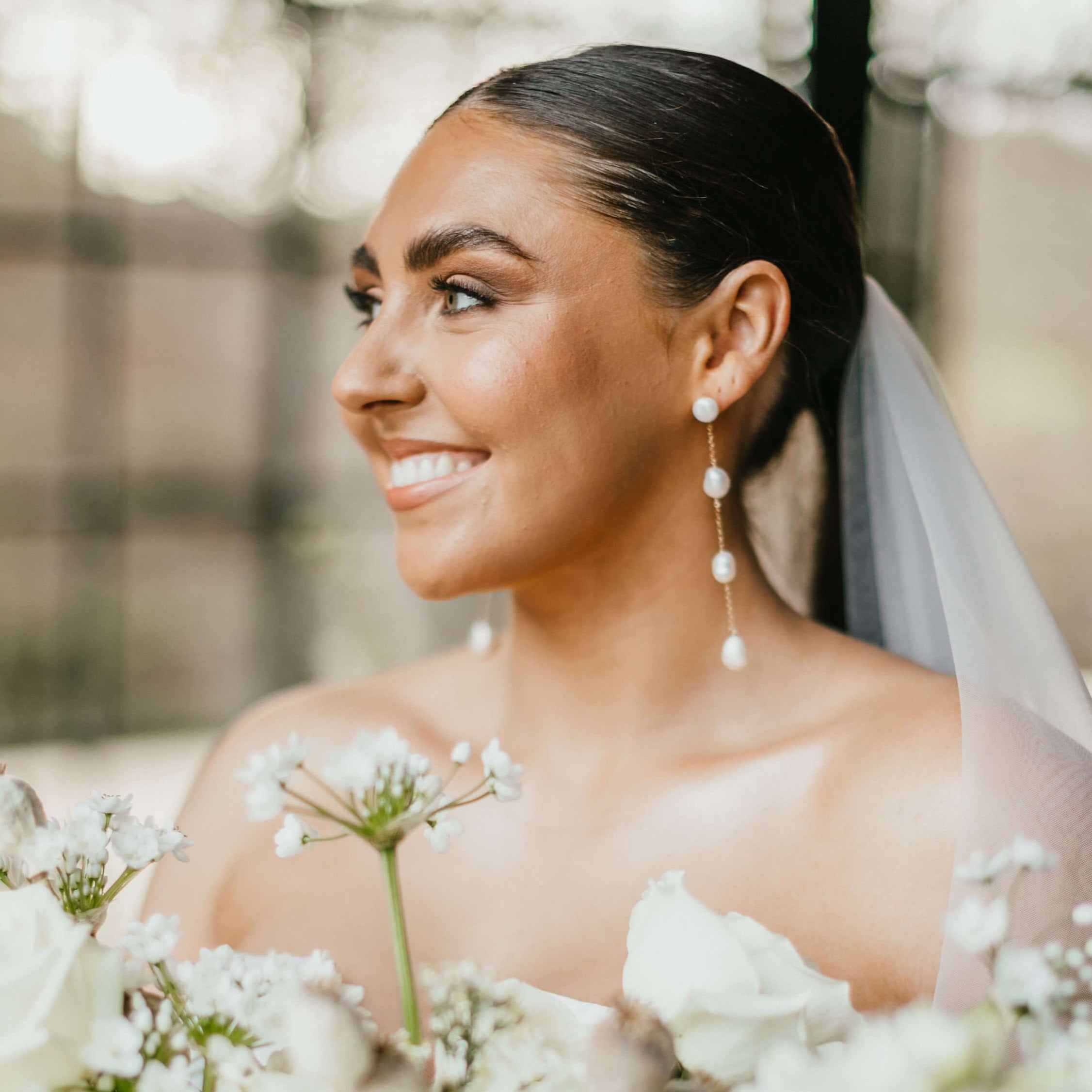 long pearl drop earrings on bridal model