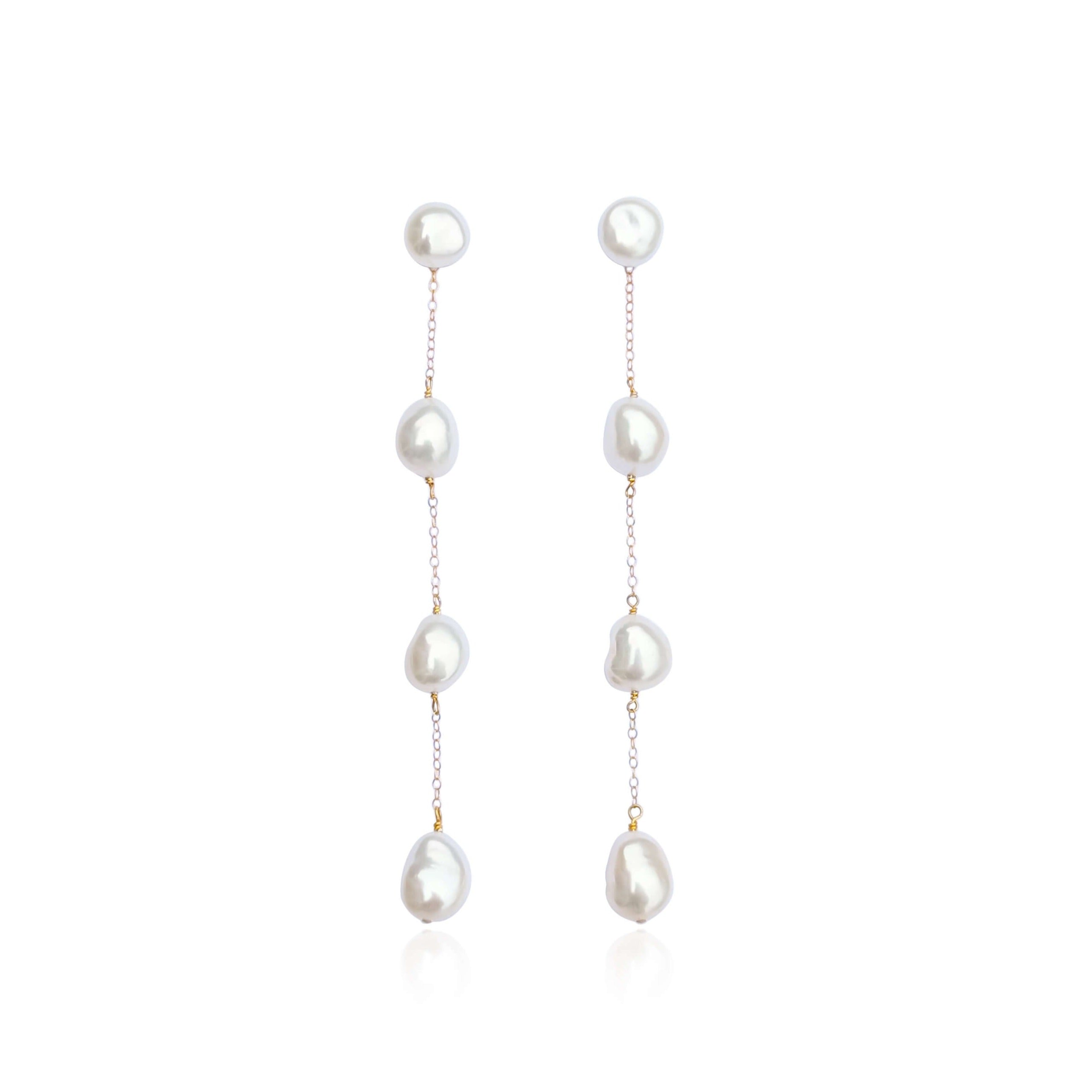 long pearl drop earrings on white background