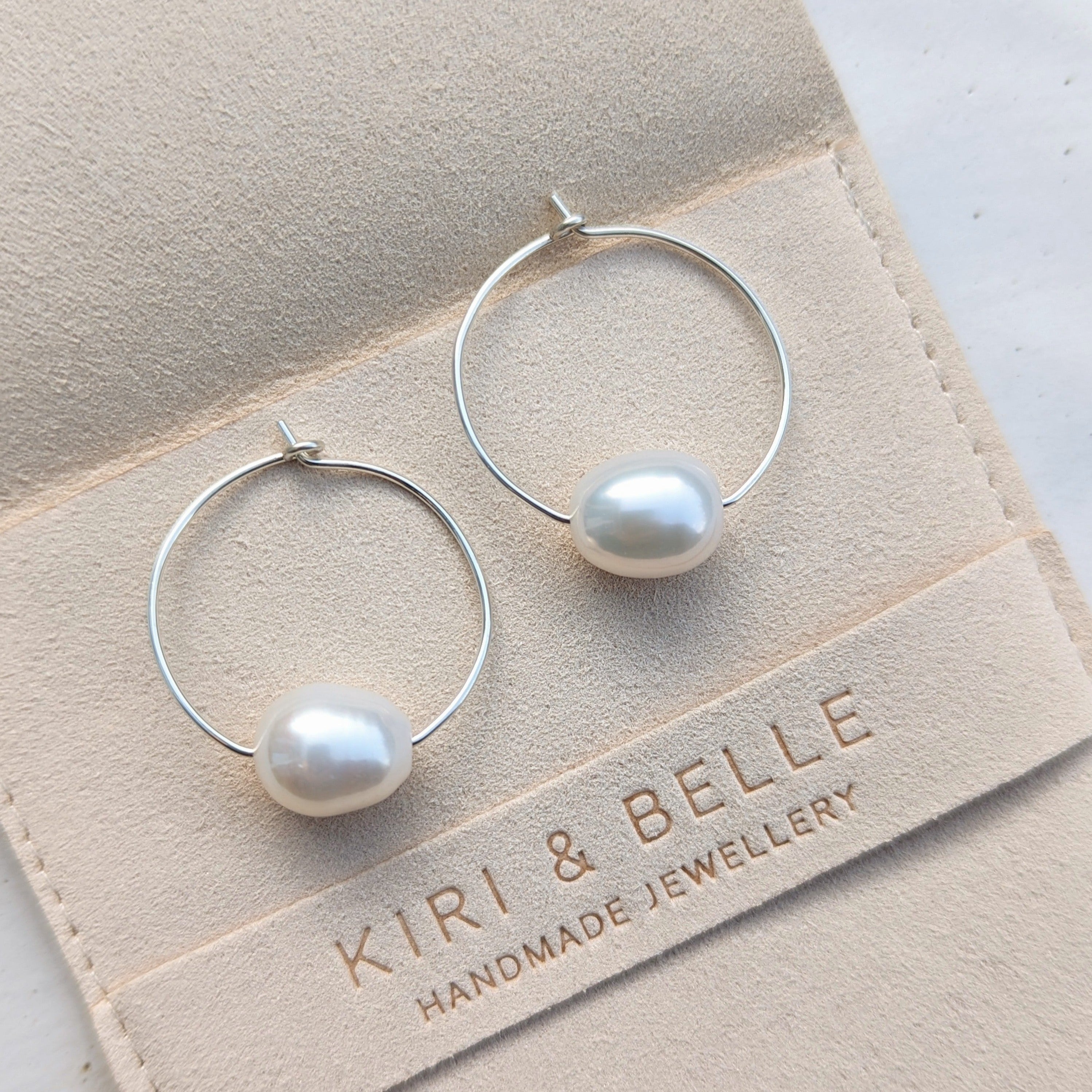 large pearl wire hoop earrings in sterling silver close up